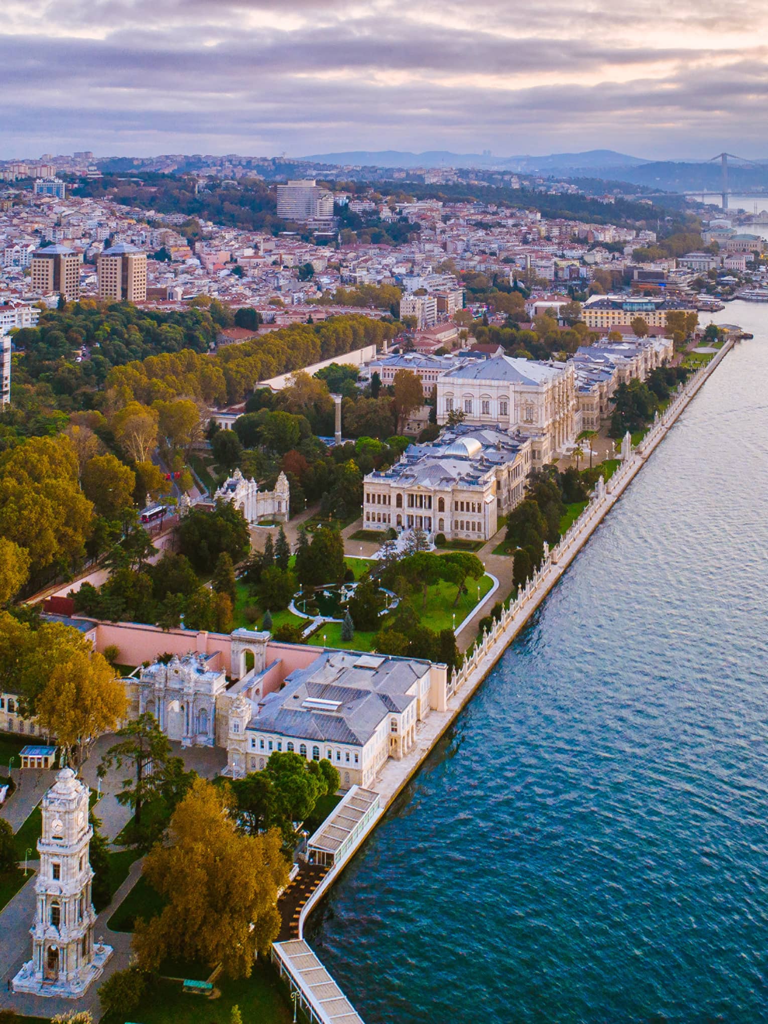 Dolmabahçe Sarayı aerial view of buildings by water at sunset