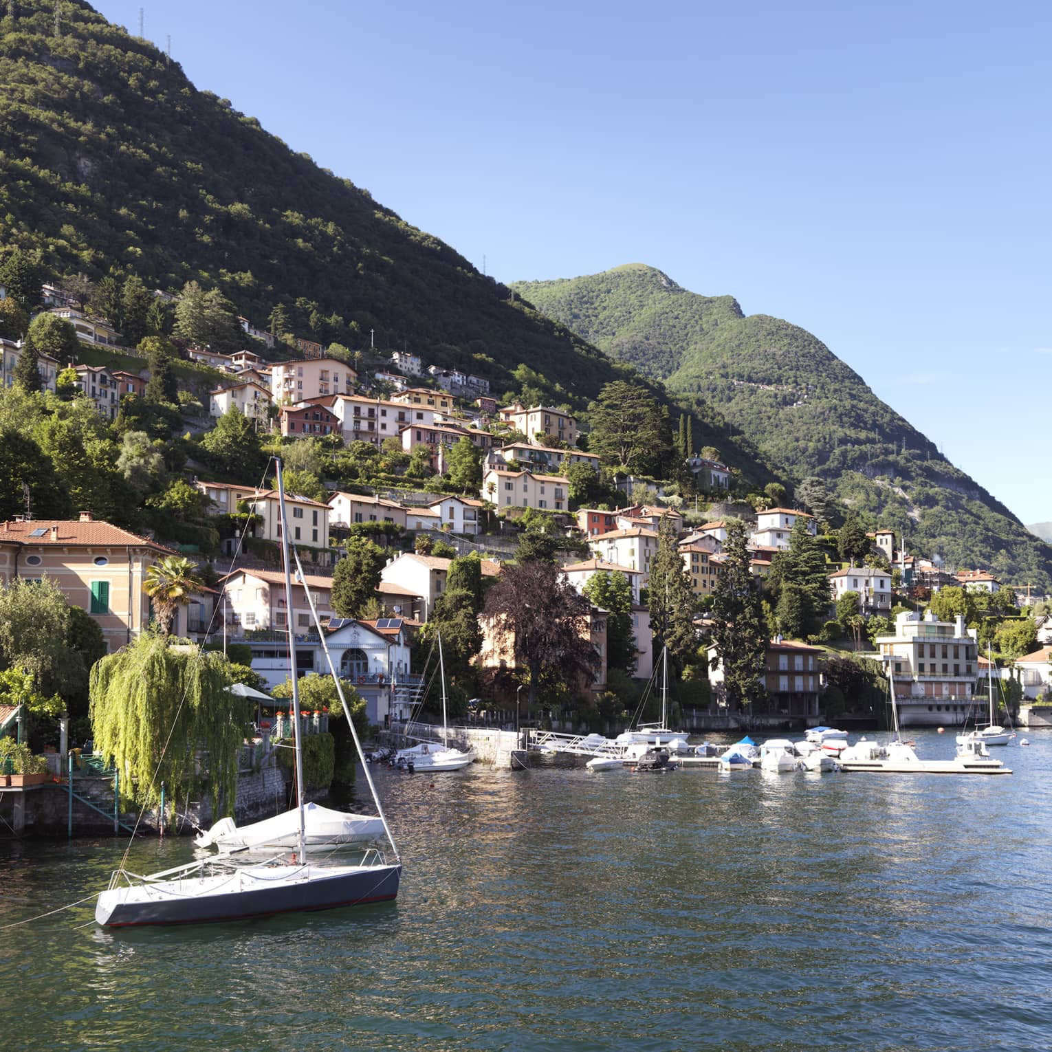 A hilled coastline with buildings on the side of the hill.