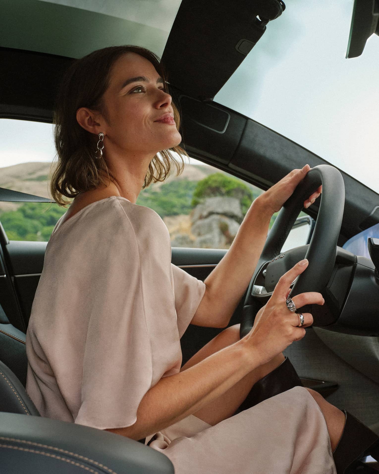 A guest looking out of the front window while driving a car
