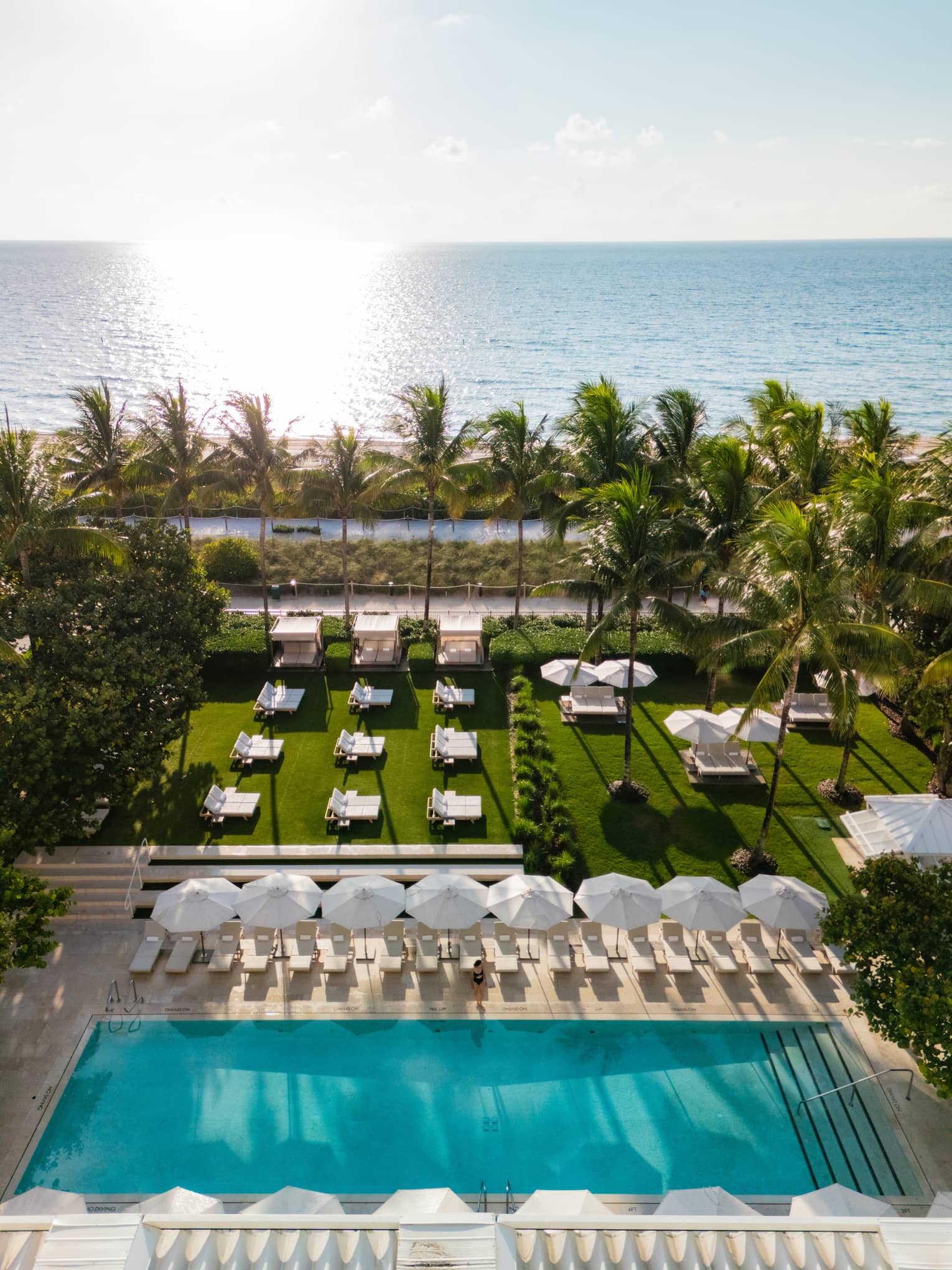 Aerial view of the outdoor pool, lounge chairs and ocean