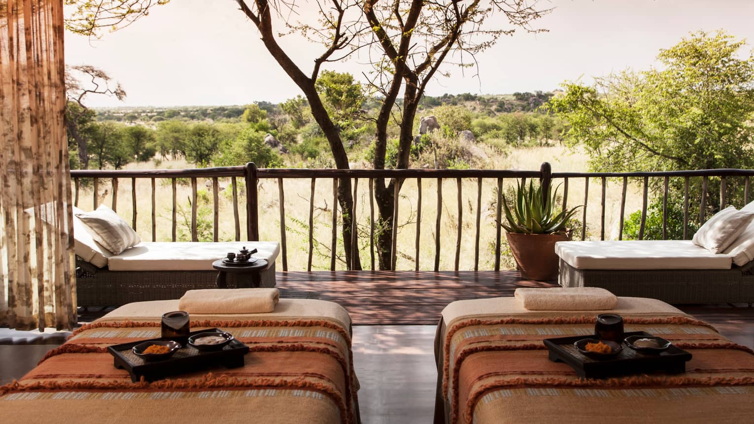 Spa couples massage beds with trays side-by-side in front of patio