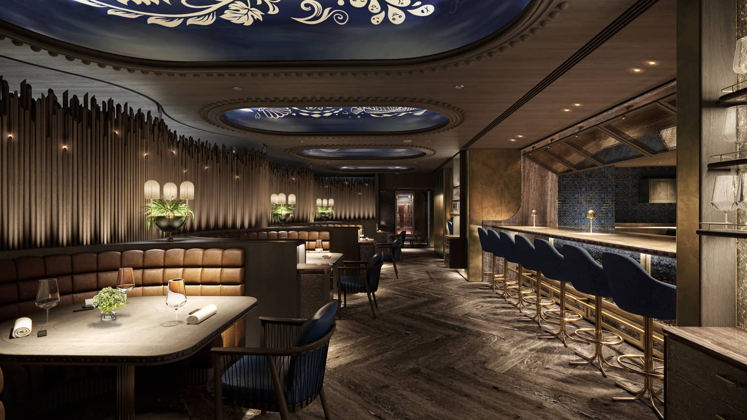Elegant restaurant interior with dim lighting, tufted leather booth seating, modern decor and a bar lined with blue upholstered stools.
