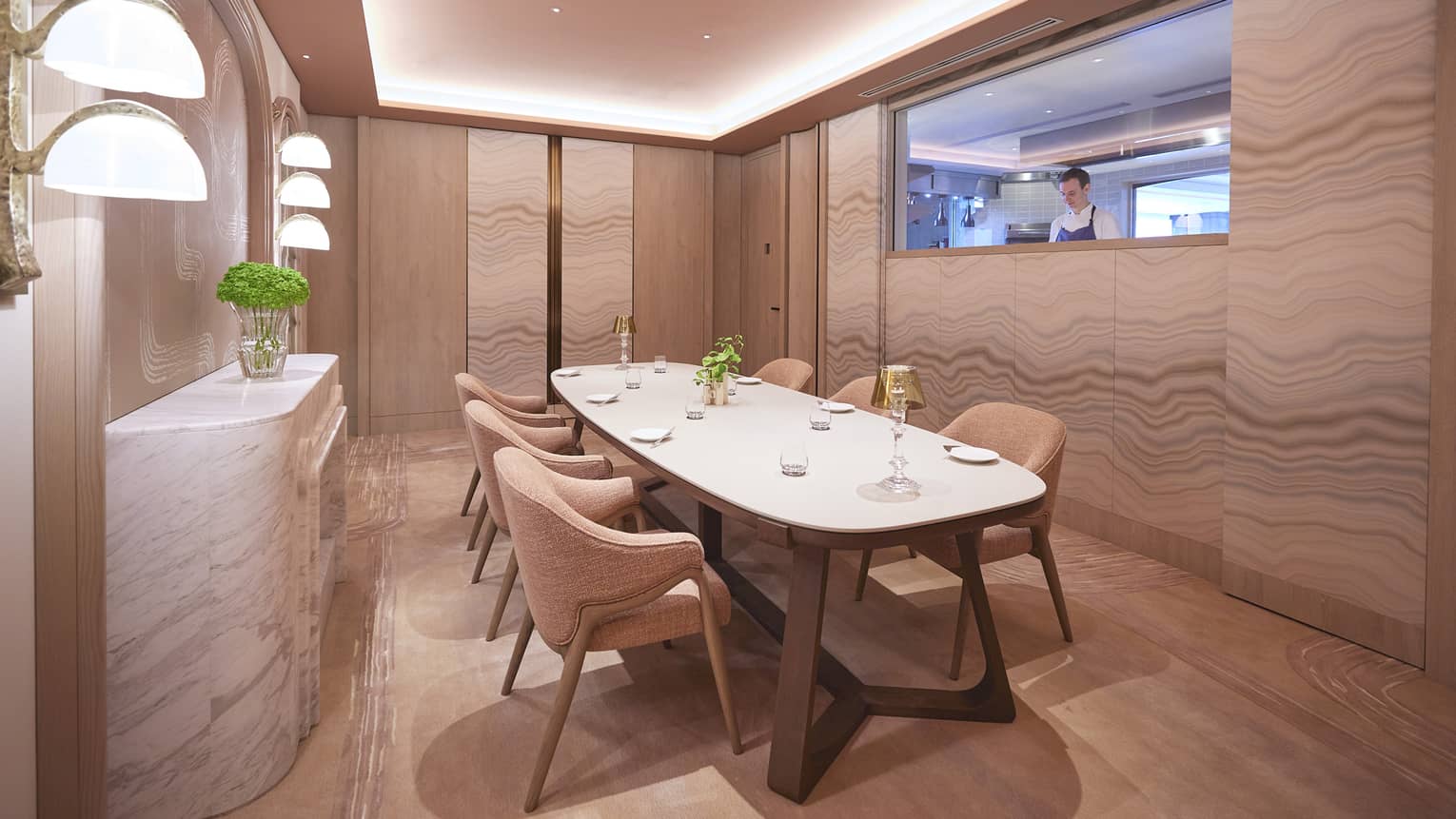 Chef?s Table private showroom with rectangular table, six armchairs, window to kitchen