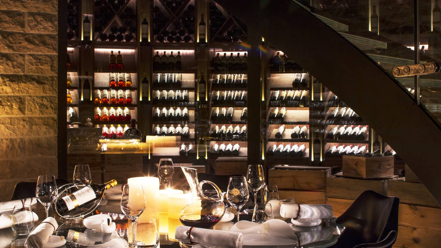 Wine Cellar dining table with bottles of wine, glasses, large candles