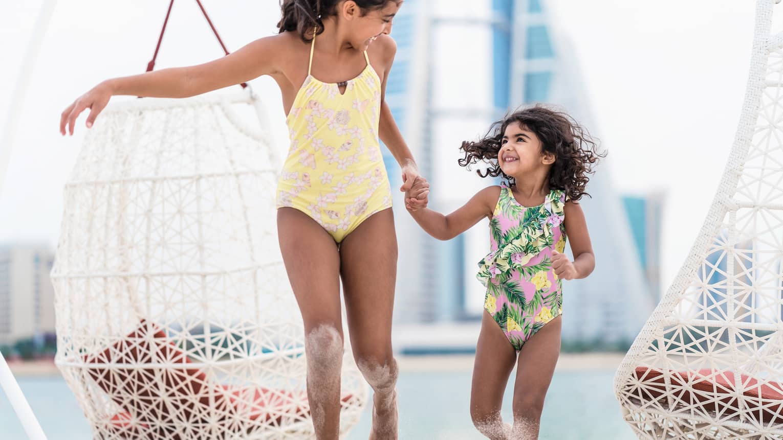Children running on sandy beach at a luxury resort