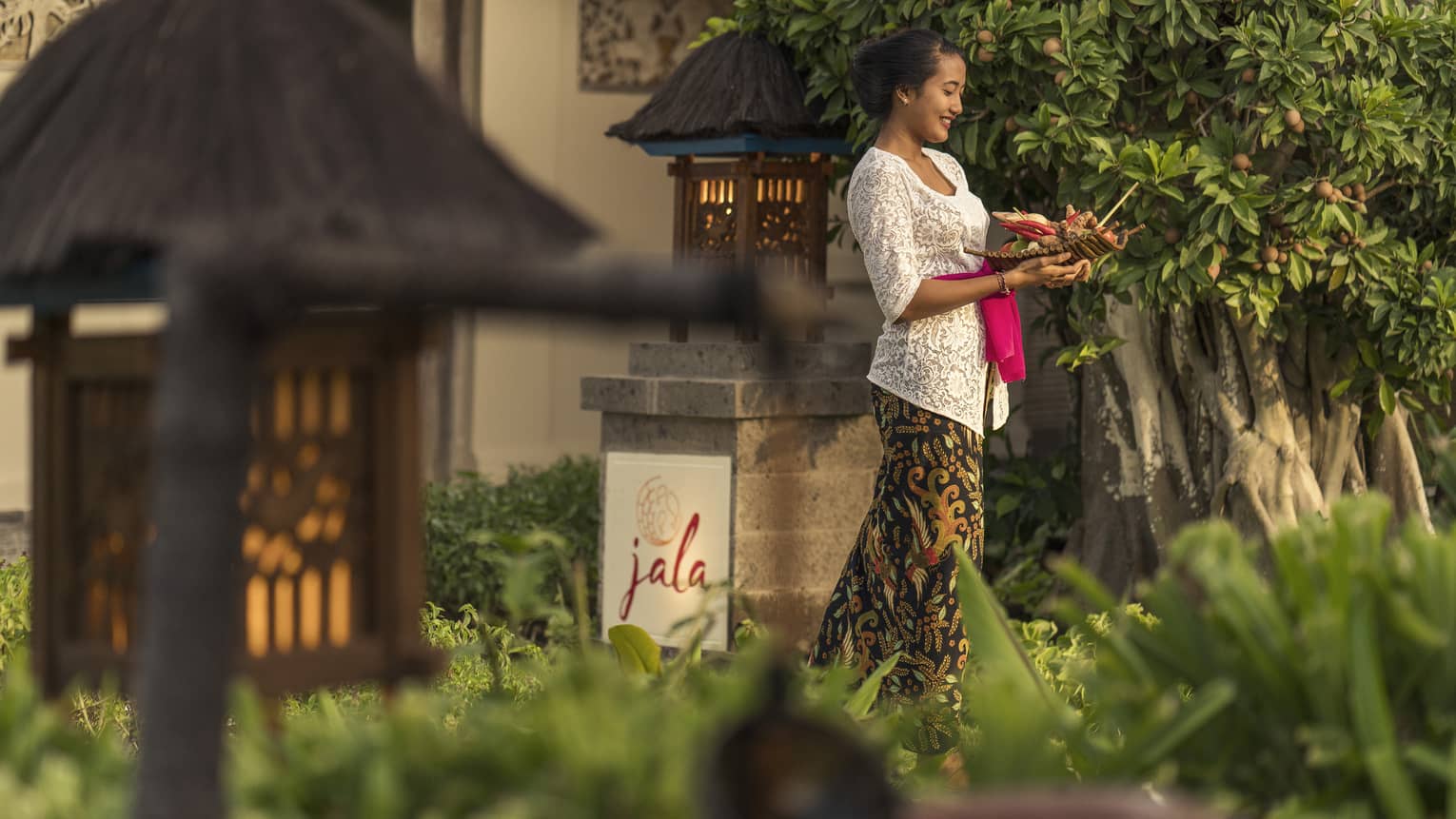 Jala Cooking Academy server walking with platter of food