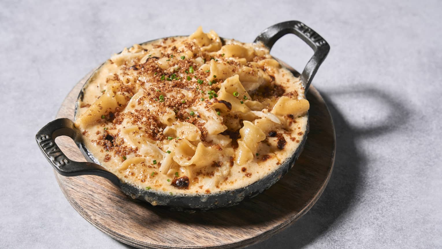 Macaroni and cheese dish with noodles and seasoning.