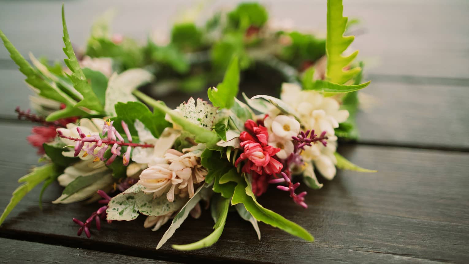 Tropical flowers arranged in floral wedding crown on table
