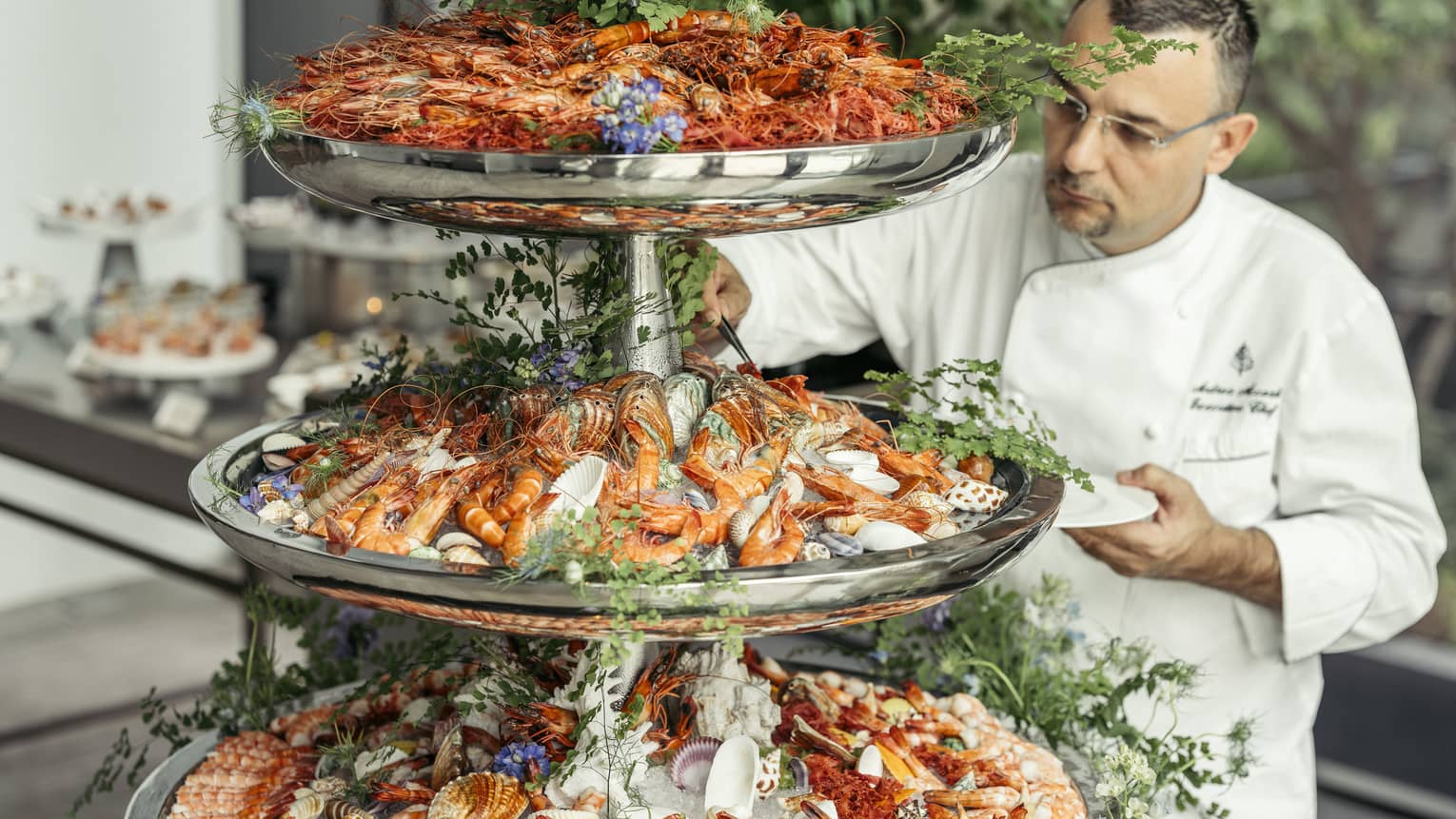 Chef puts finishing touches on three-tiered seafood display