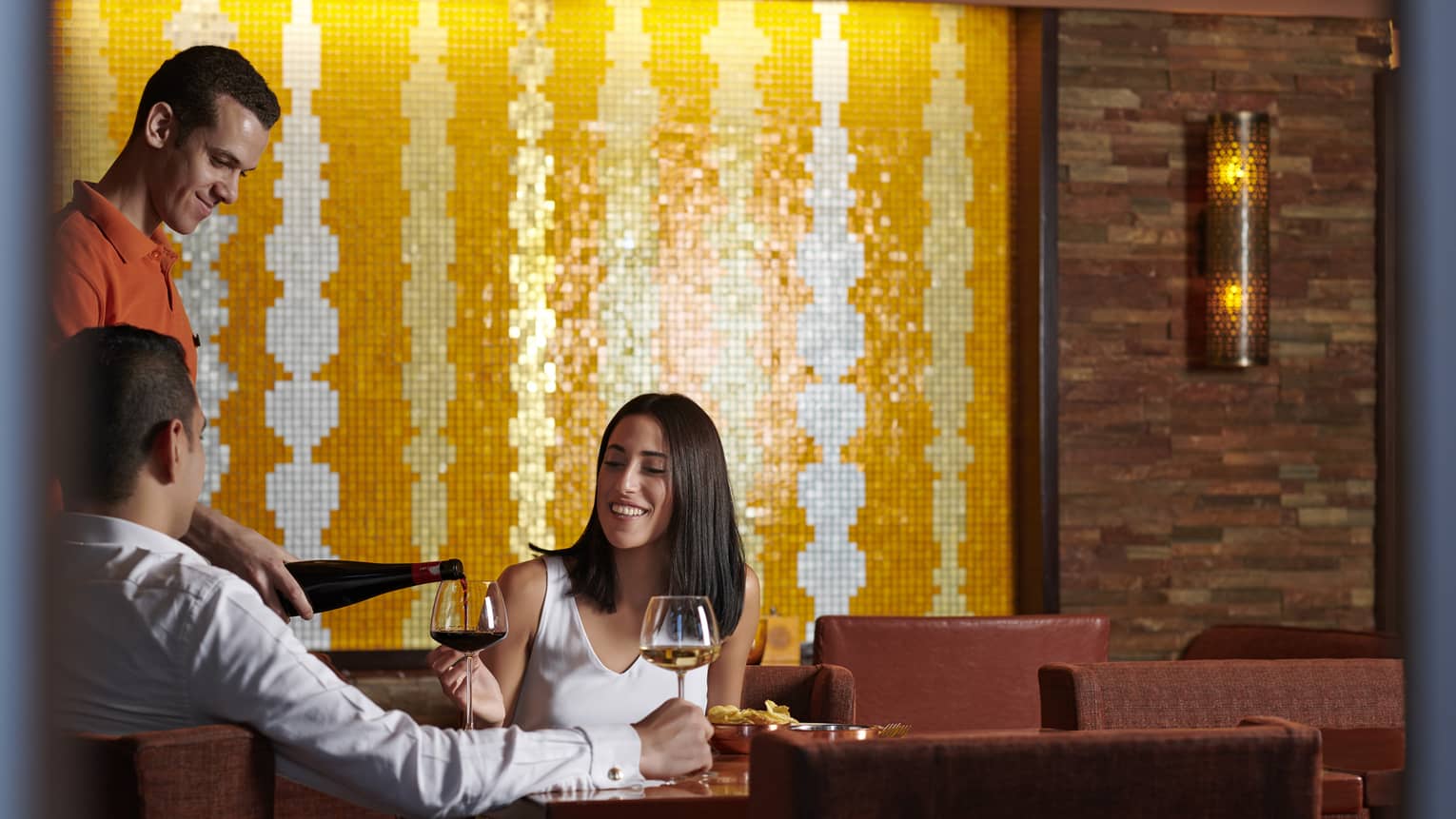 Couple enjoys a casual meal with wine at Aura