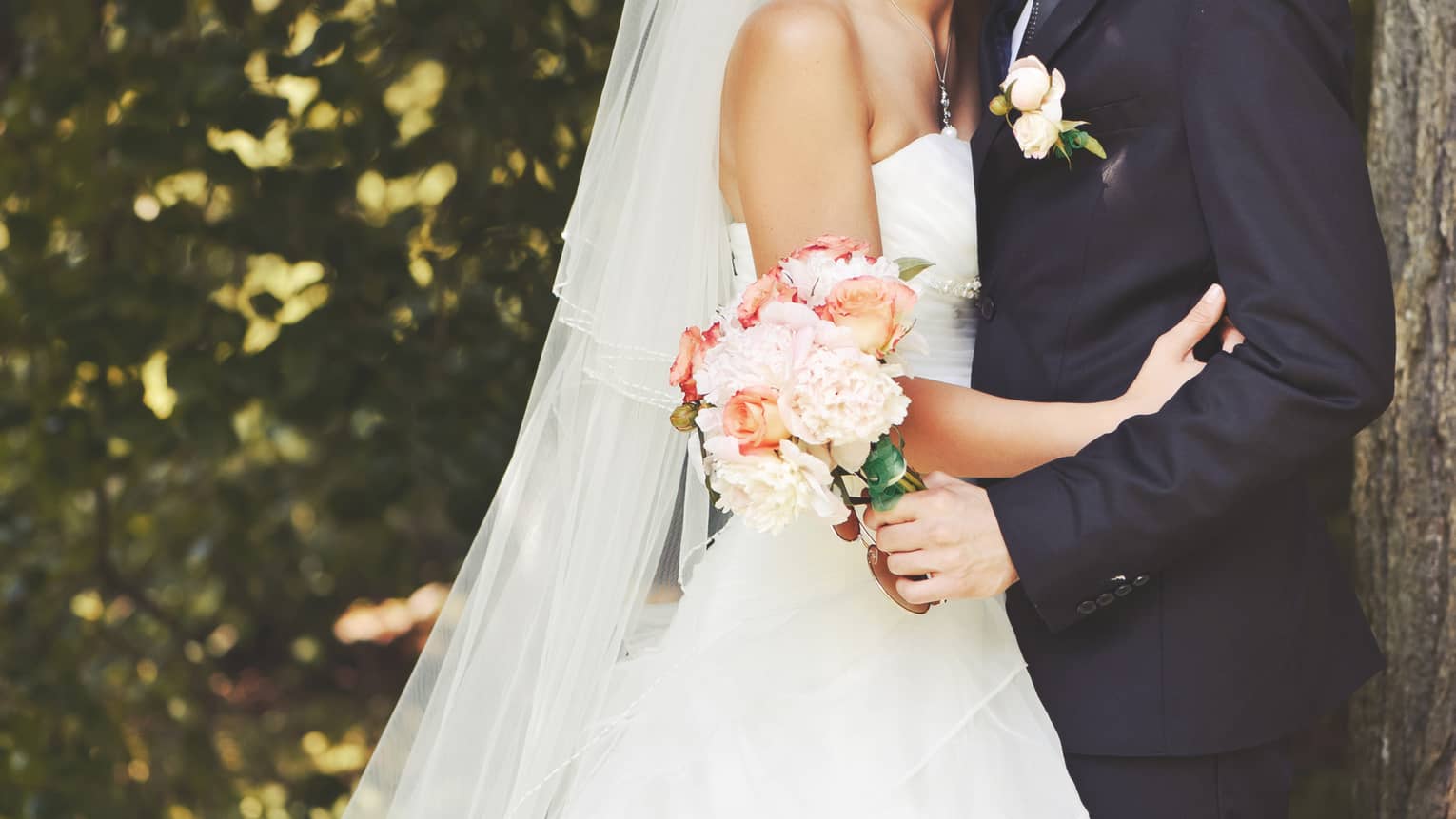 Close up of bride and groom embracing 