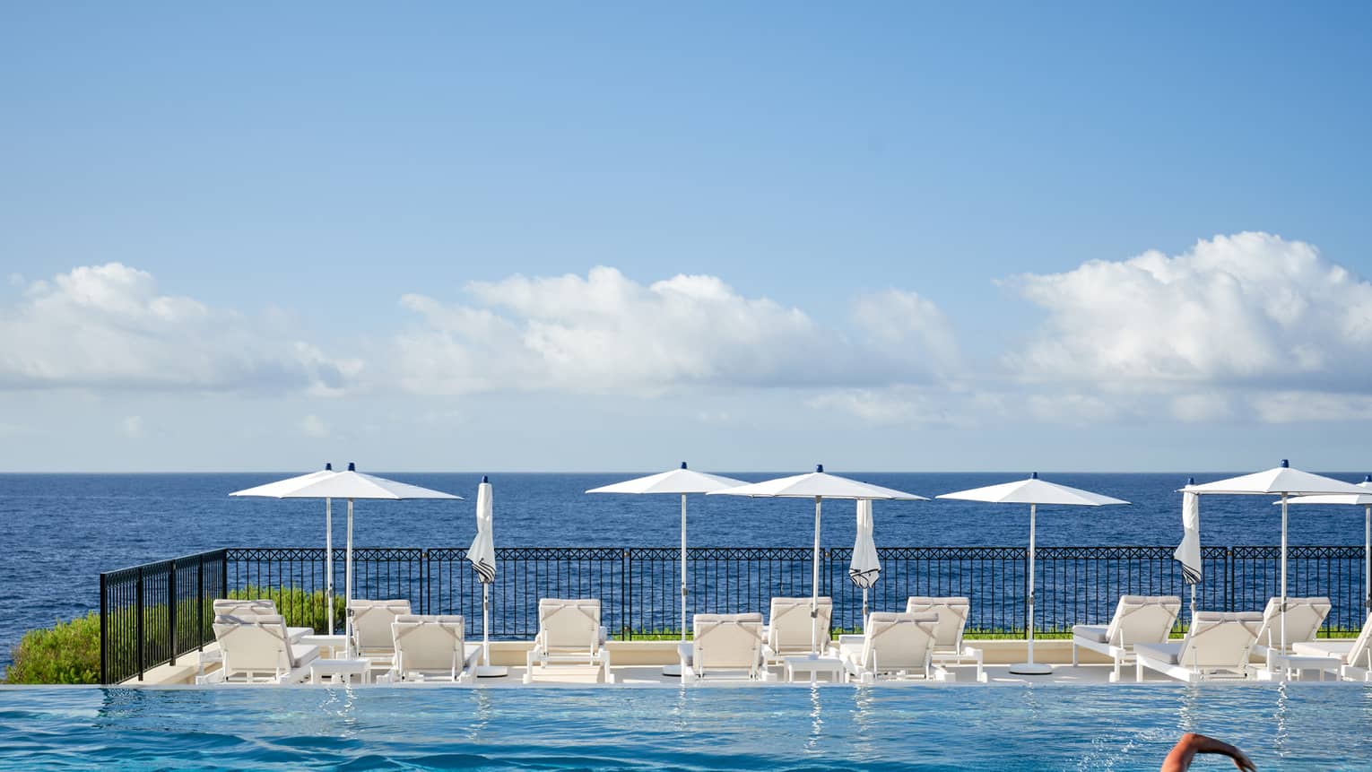 Man swimming in infinity pool