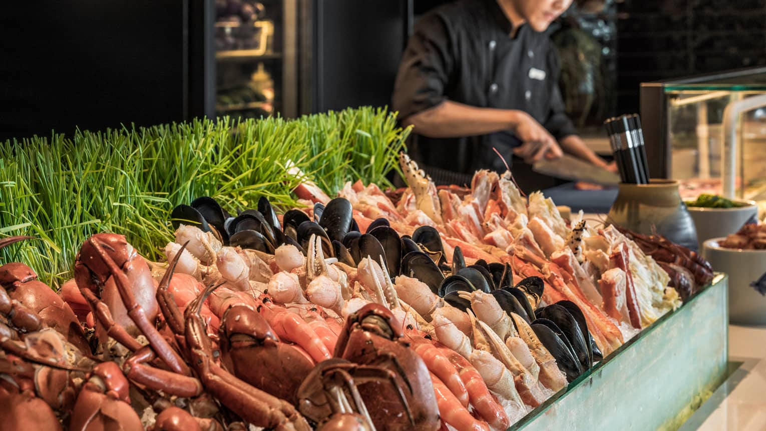 Curate seafood station with chef laying out food