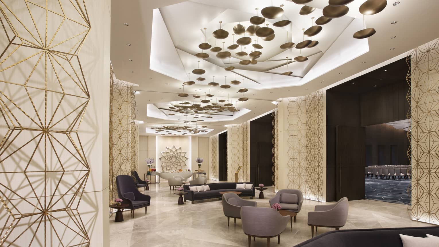 Light-filled contemporary meeting space with grey lounge chairs 