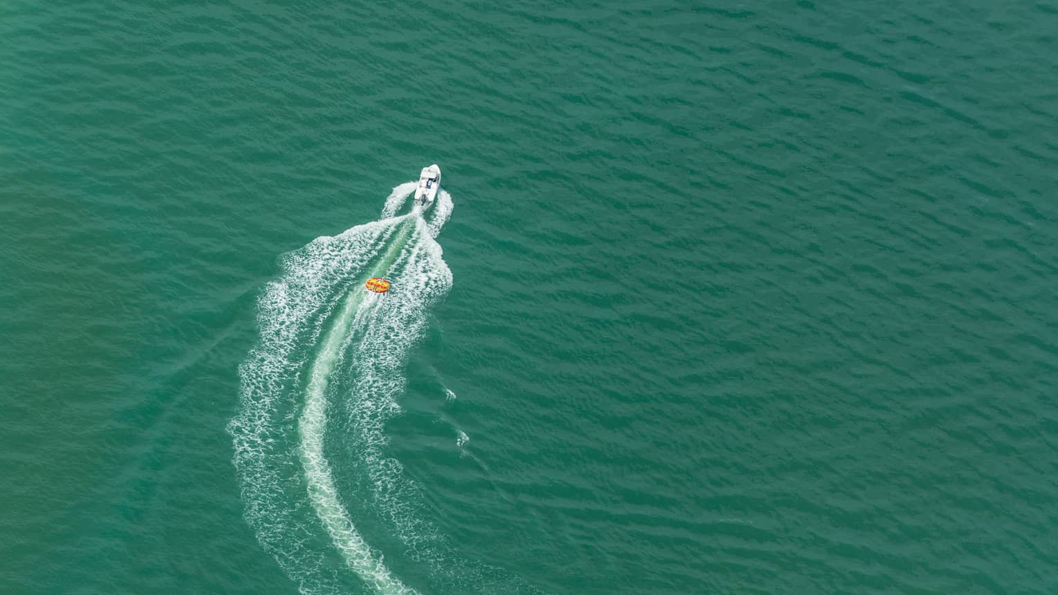 Aerial view of a boat moving through the ocean.