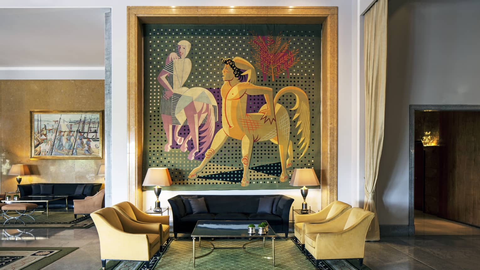 Almada Negreiros Lounge yellow armchairs below large handmade tapestry depicting centaurs