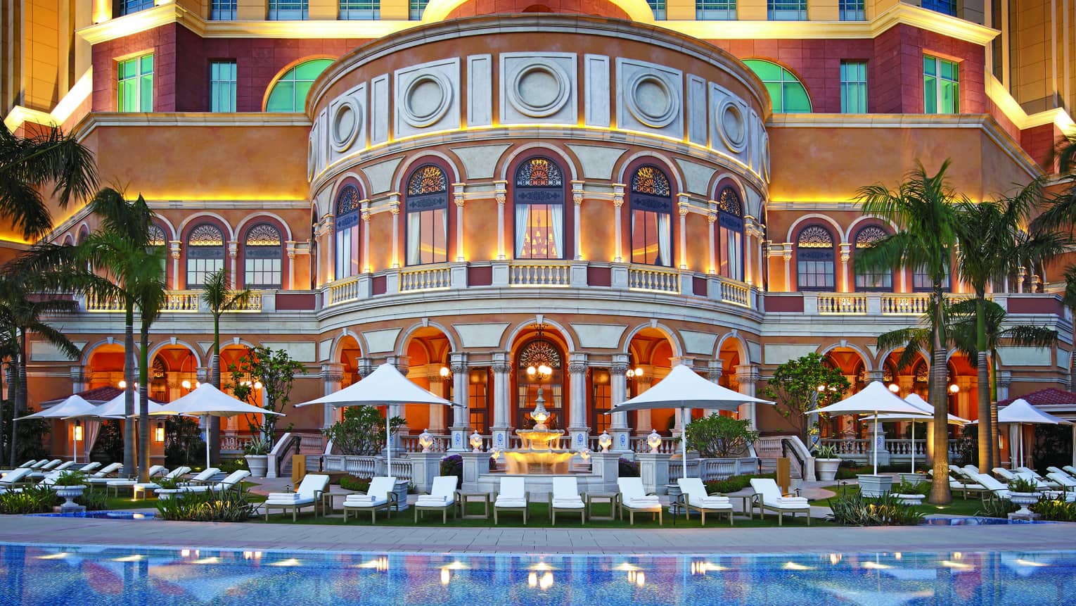 Macao Cotai Strip Four Seasons Hotel arched windows, curved exterior over pool chairs on deck