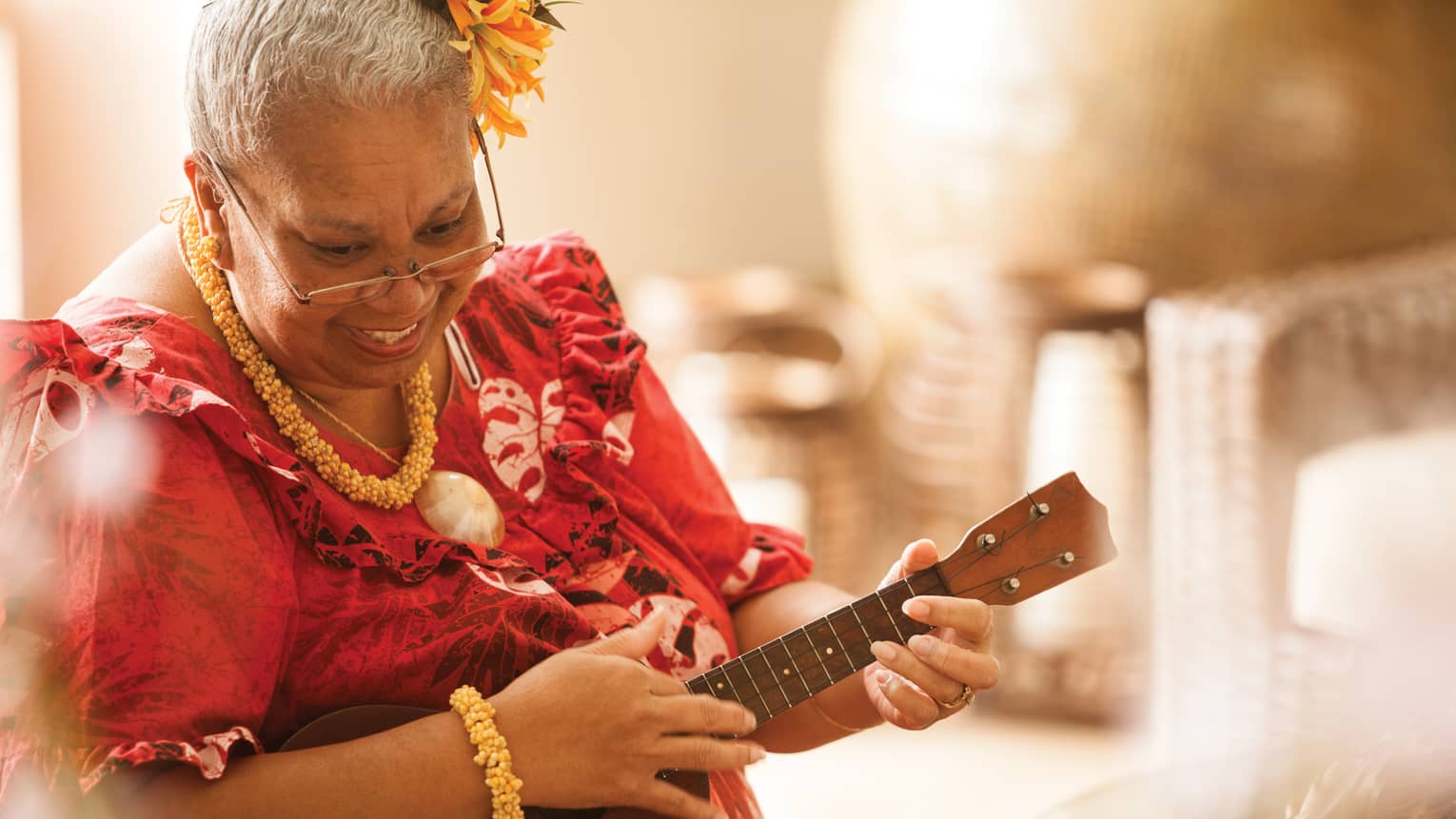 Close-up of Hawaiian elder playing ukulele