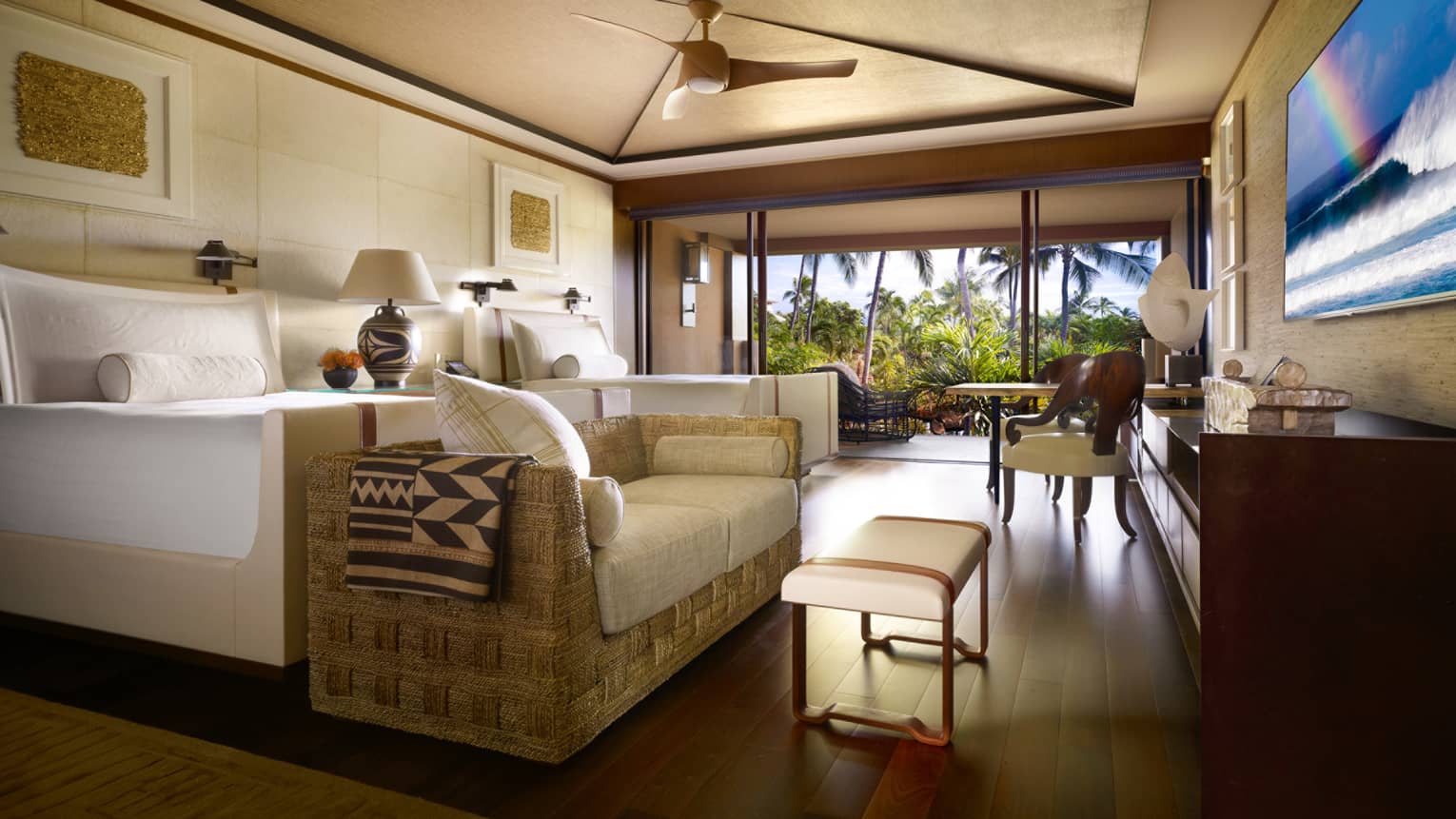 Garden-View Room bed, wicker sofa with white cushions, bench at foot, open wall to patio