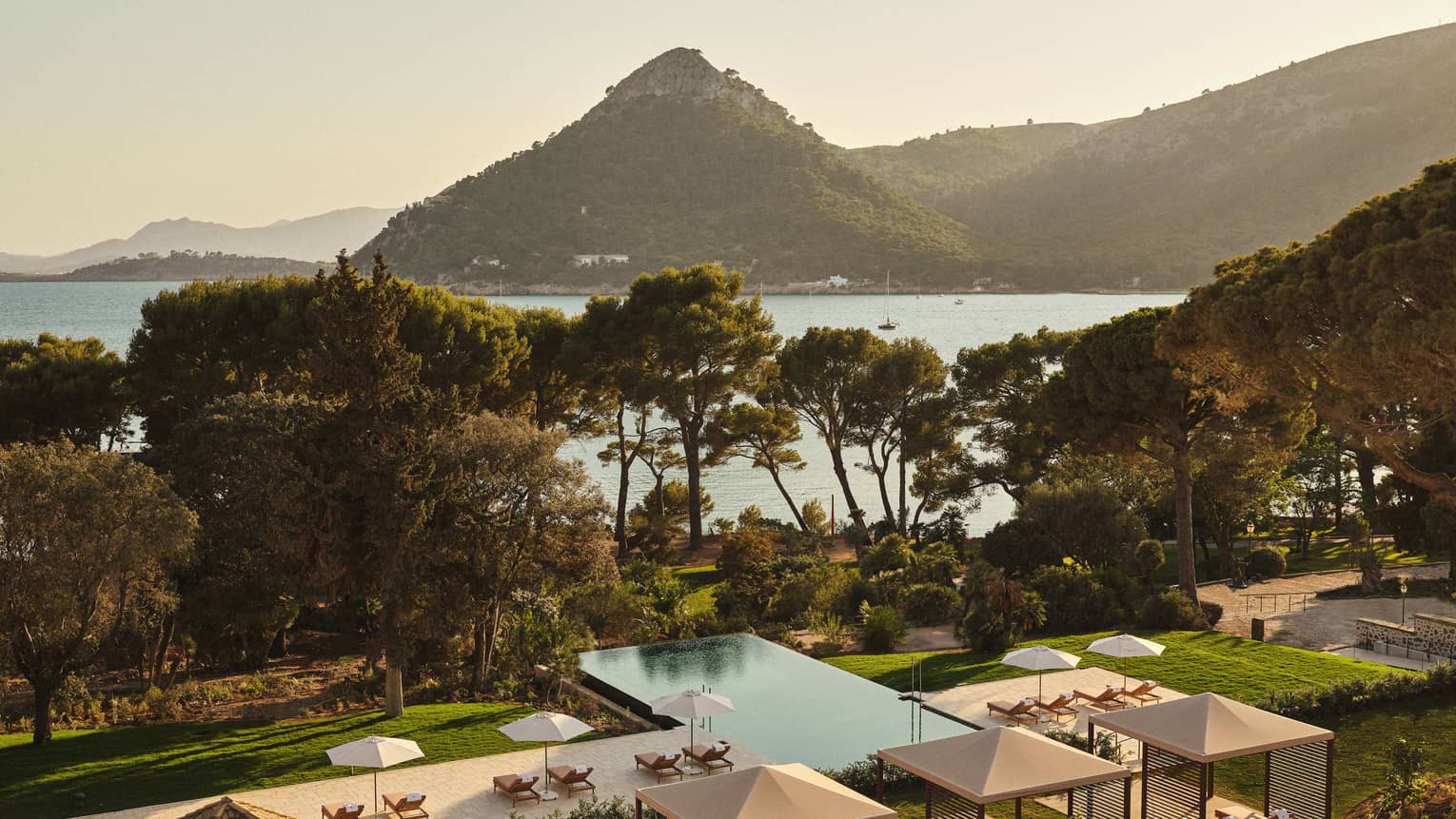 View of pool and ocean/mountain in background