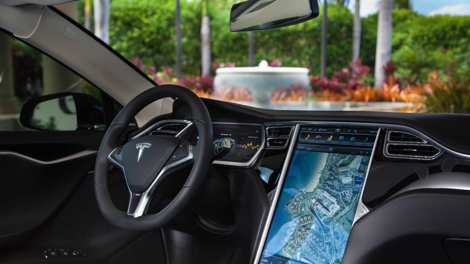 Close-up of Tesla car wheel, dashboard with touchscreen