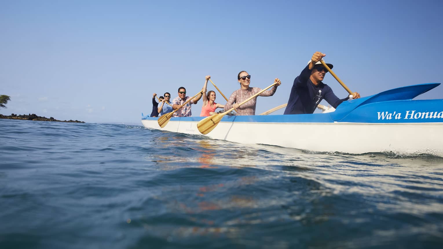 A group of guests kayaking on the ocean