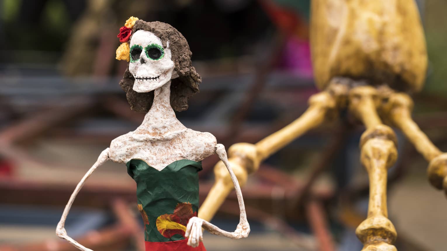 Painted skeleton wearing green dress.