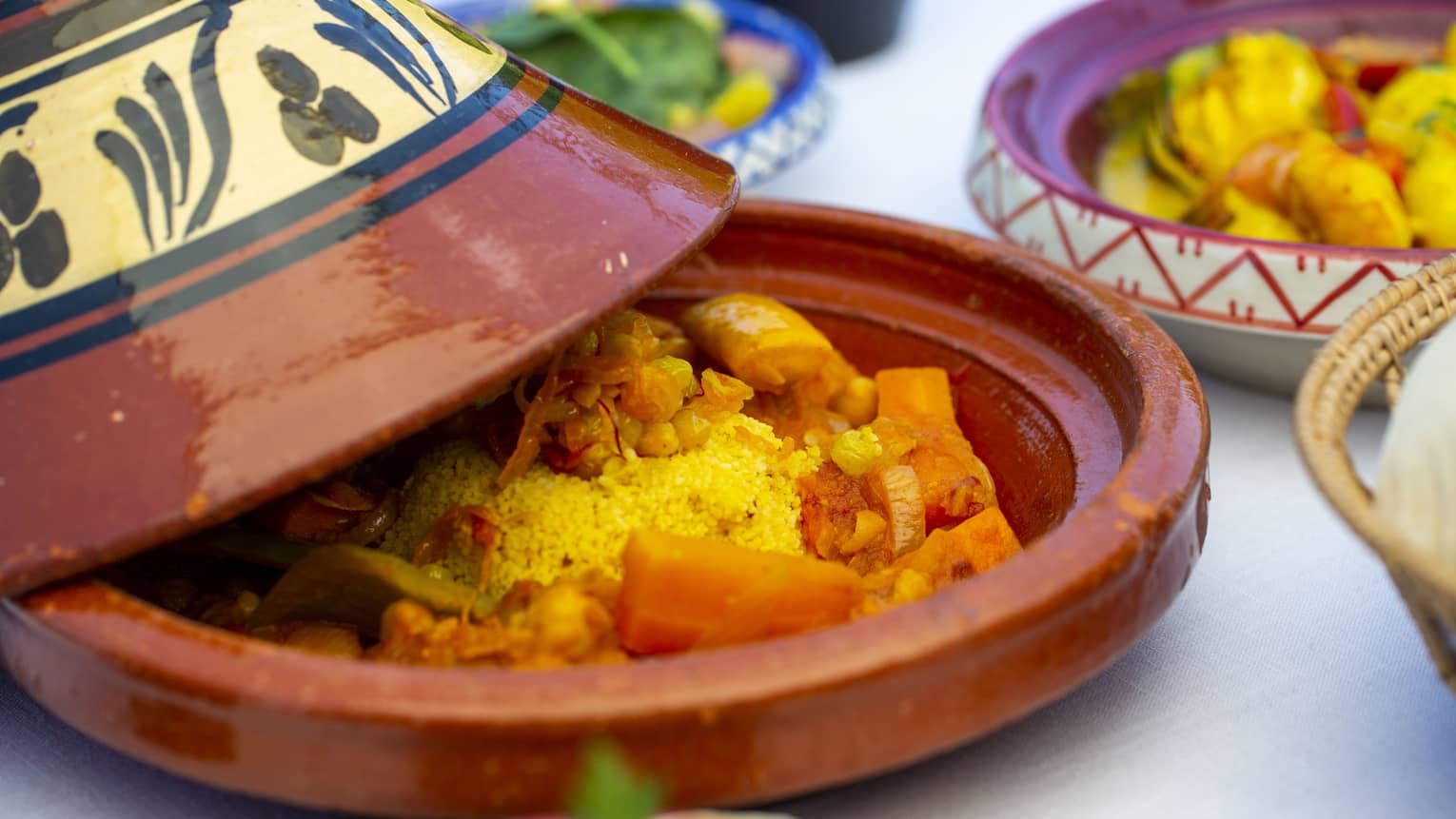 A close up of a vegetable dish in a terracotta plate with cover at Al Barakat