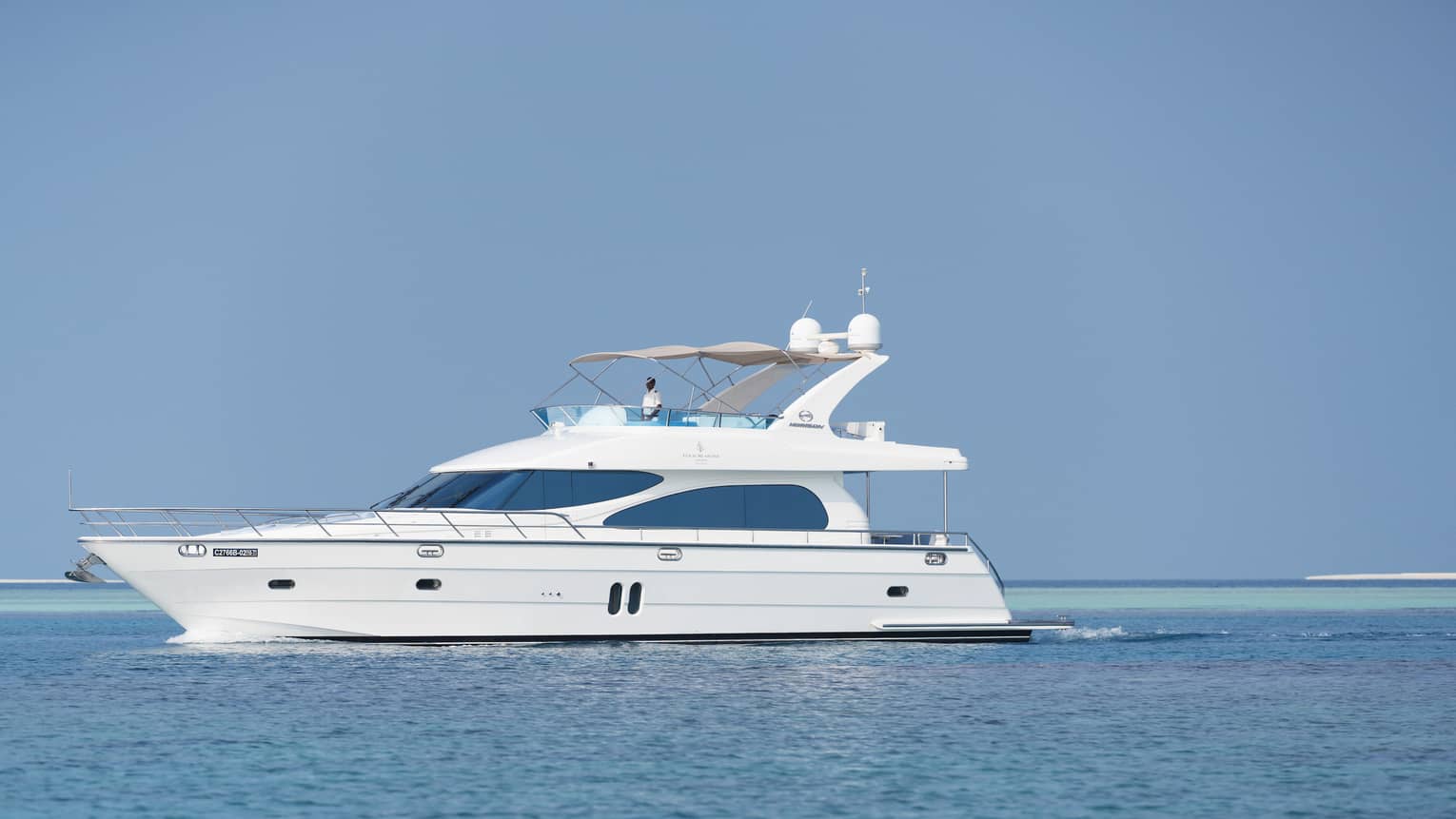 Small white private luxury yacht sailing on ocean