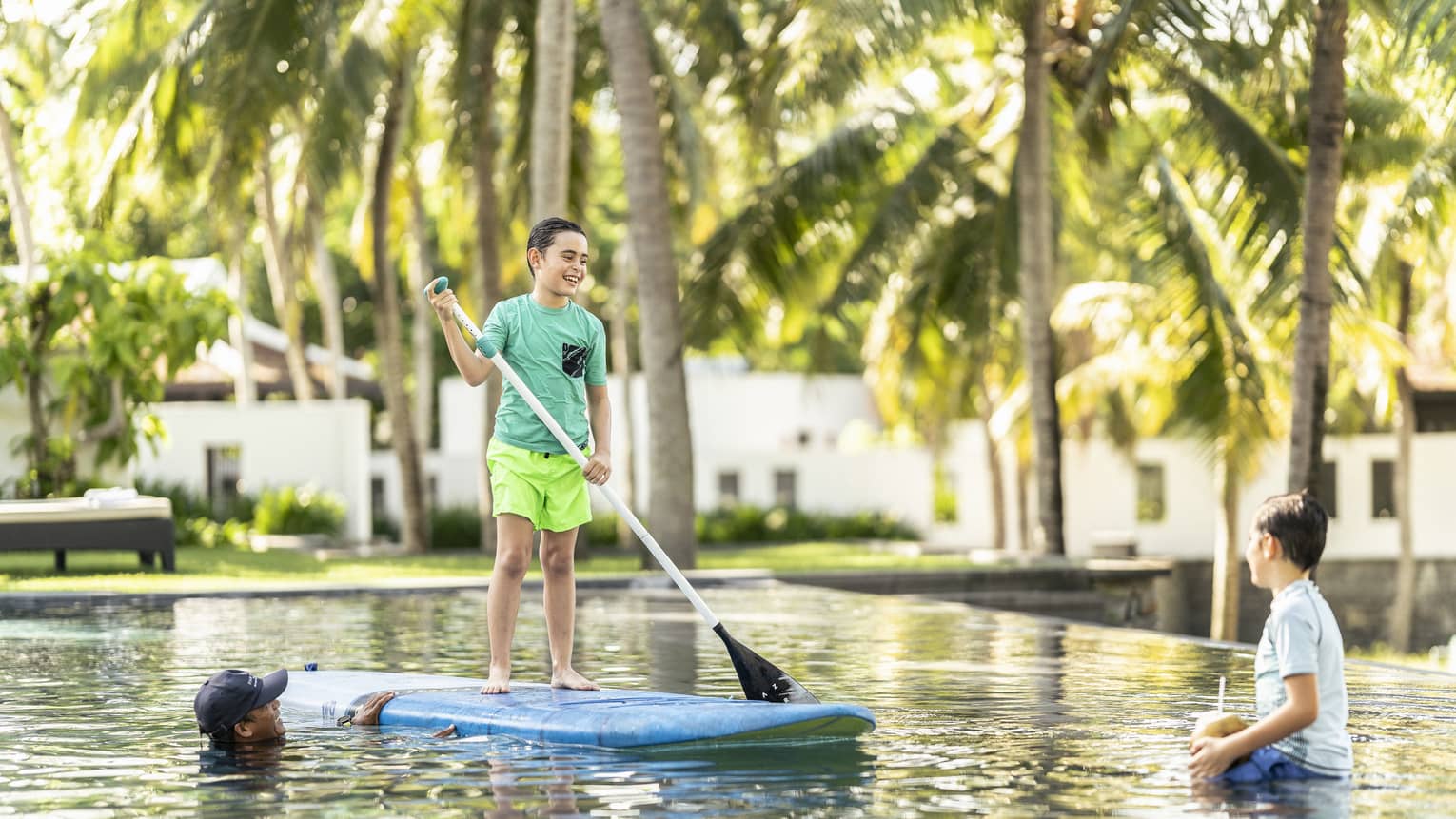 Two young boys participate in a private SUP lesson with instructor