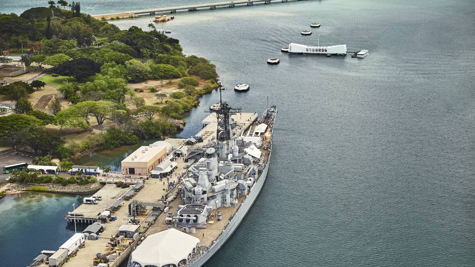 Aerial view of large battleship, people on dock at Battleship Missouri Memorial at Pearl Harbor