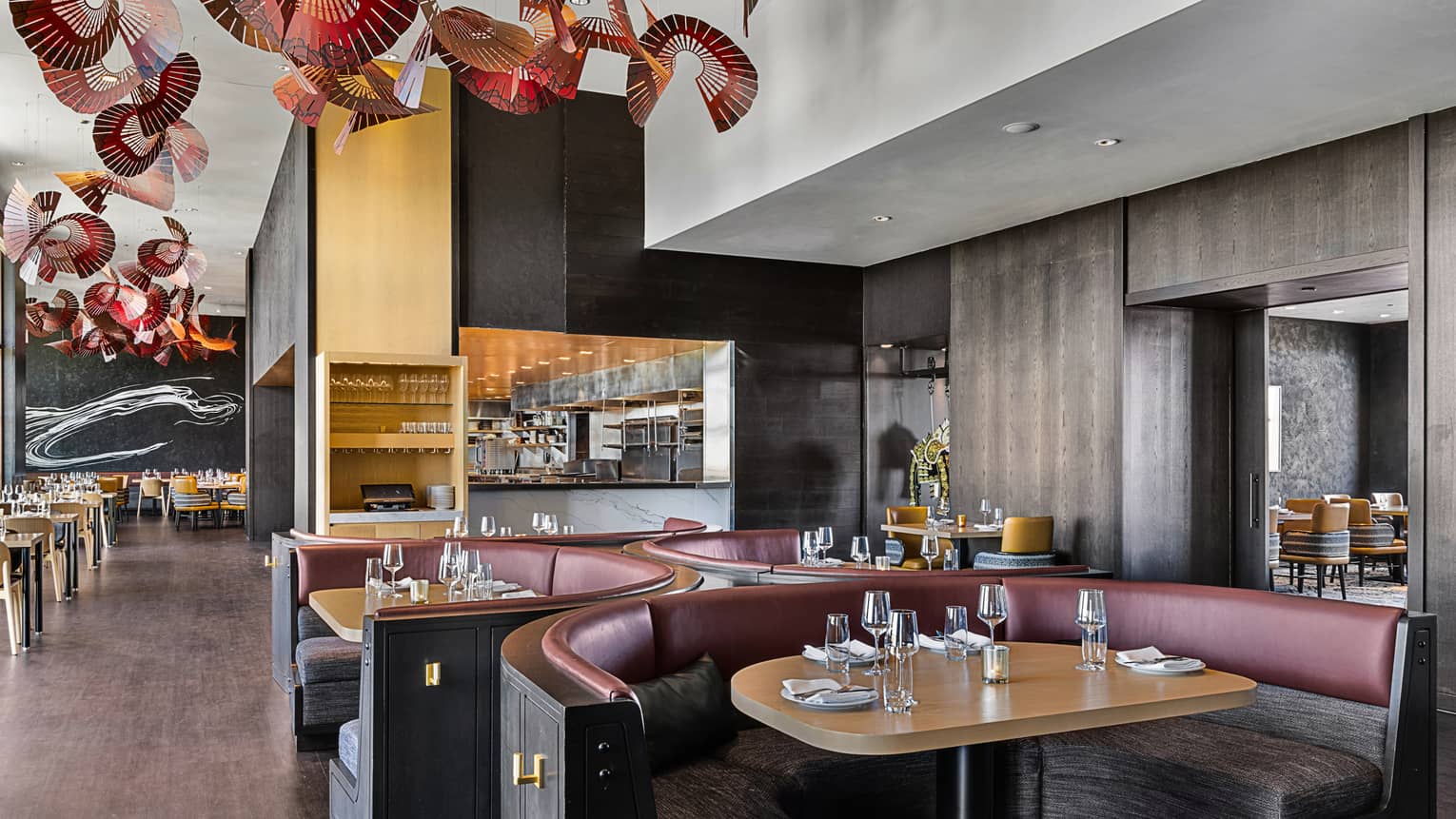 Capa restaurant with three table booths and red ceiling decor.