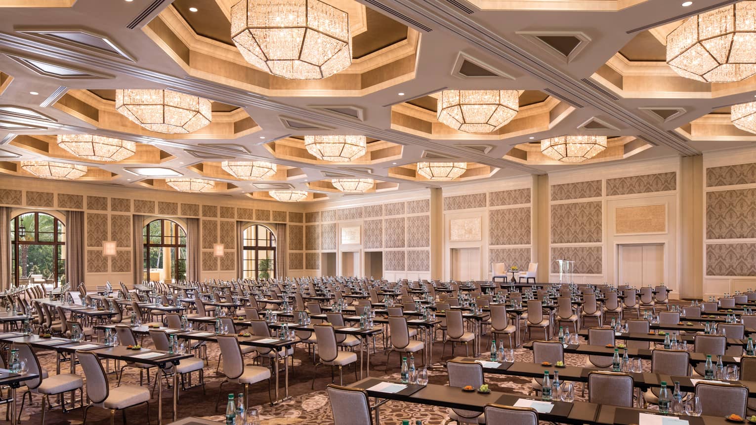 Rows of meeting tables, chairs in large Grand Ballroom under lights 