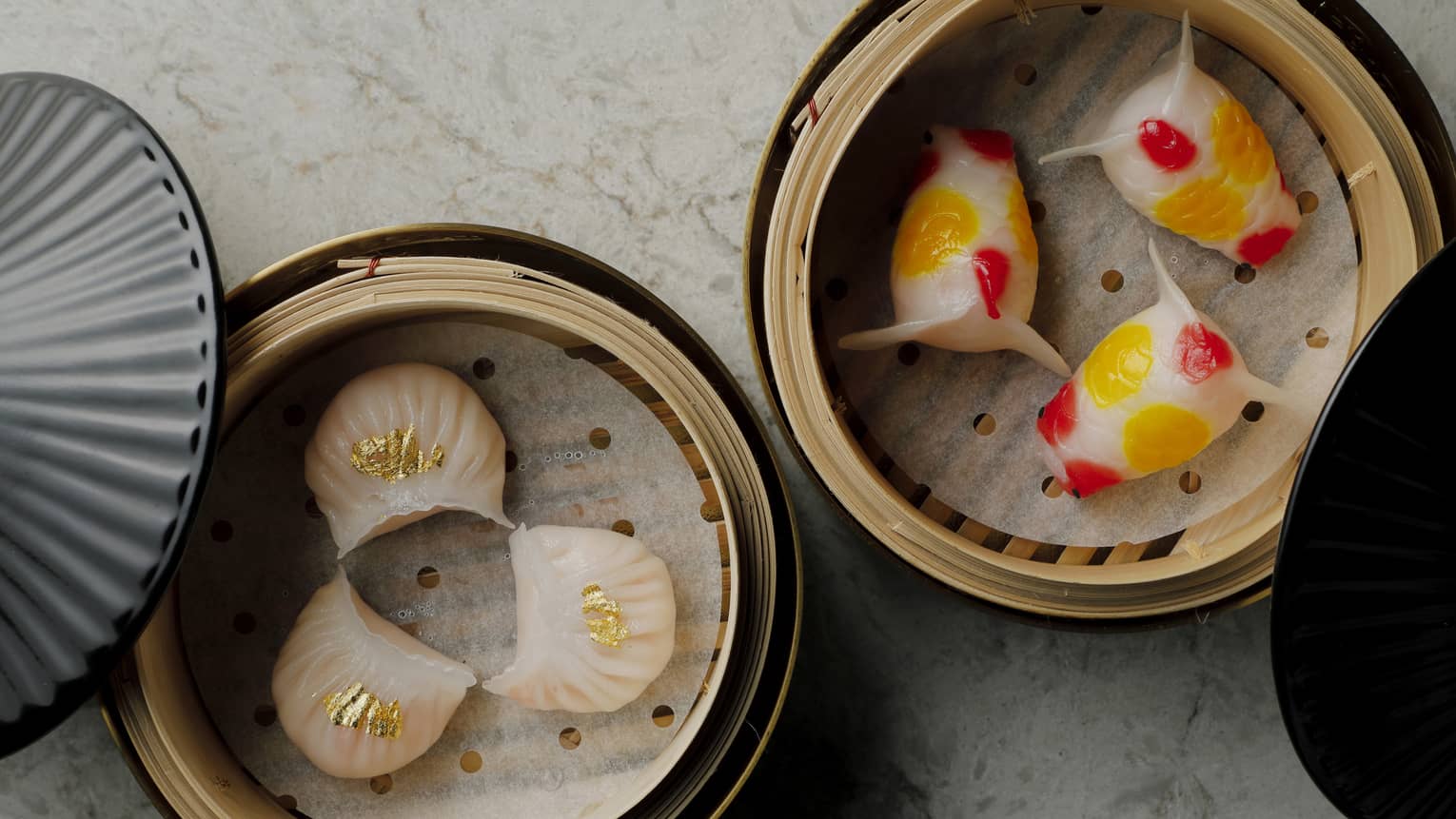 Aerial view of two different types of dim sum in steamer baskets