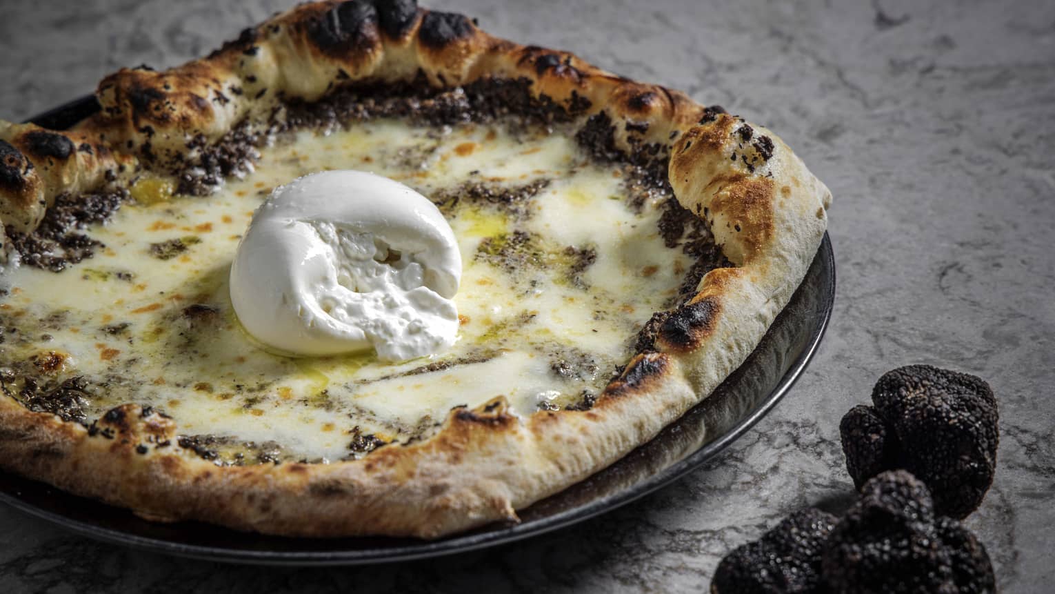 Truffle pizza with a ball of burrata in the middle