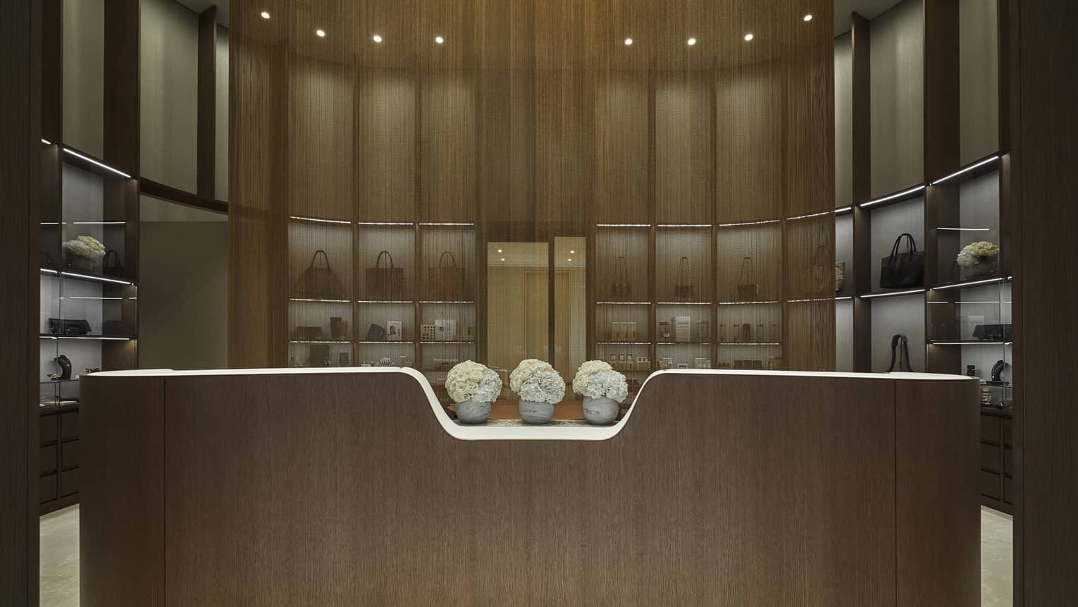 Entrance of the Spa boutique with three vases of white flowers.