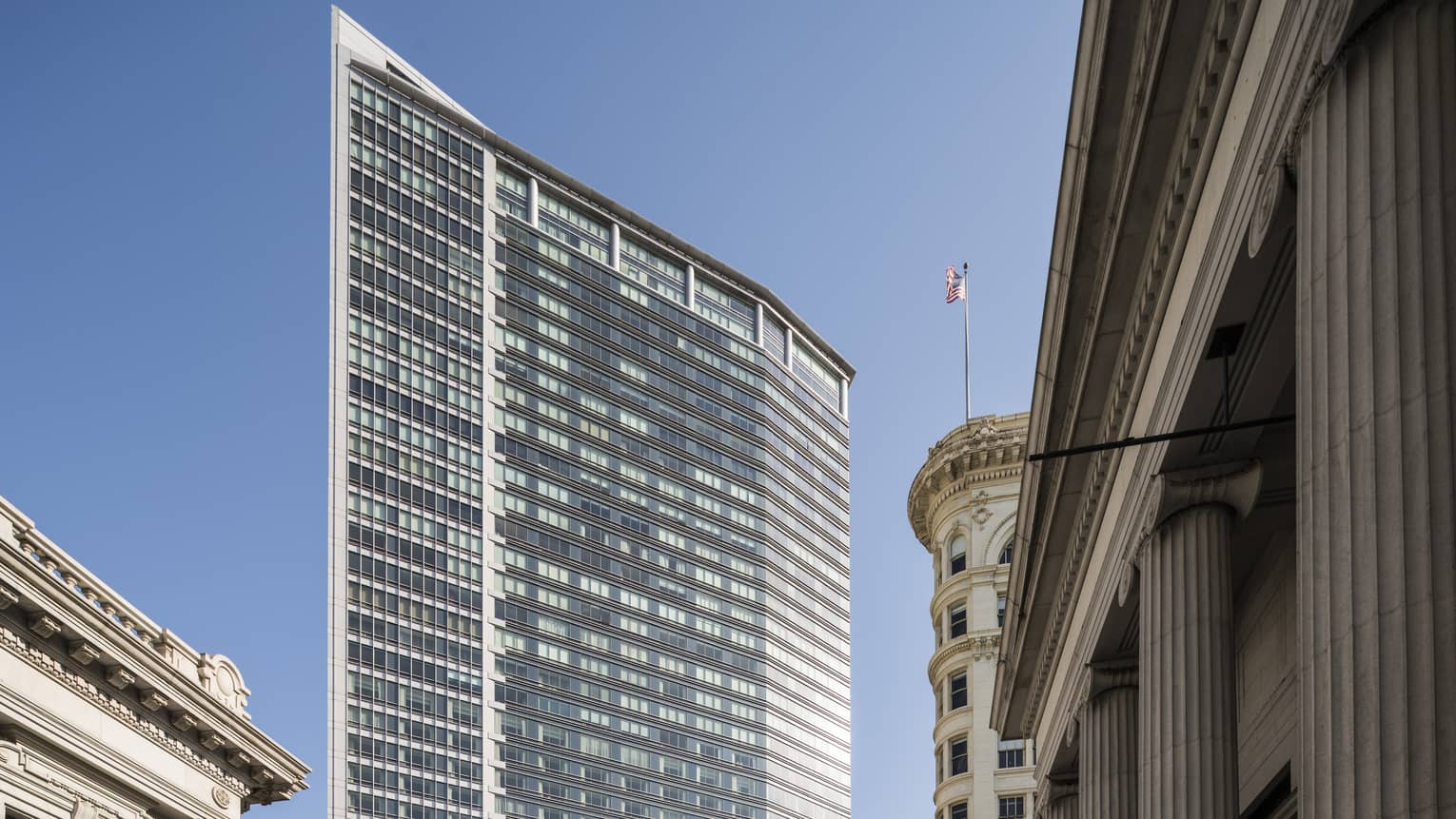 Four Seasons Hotel San Francisco glass high rise building exterior against blue sky