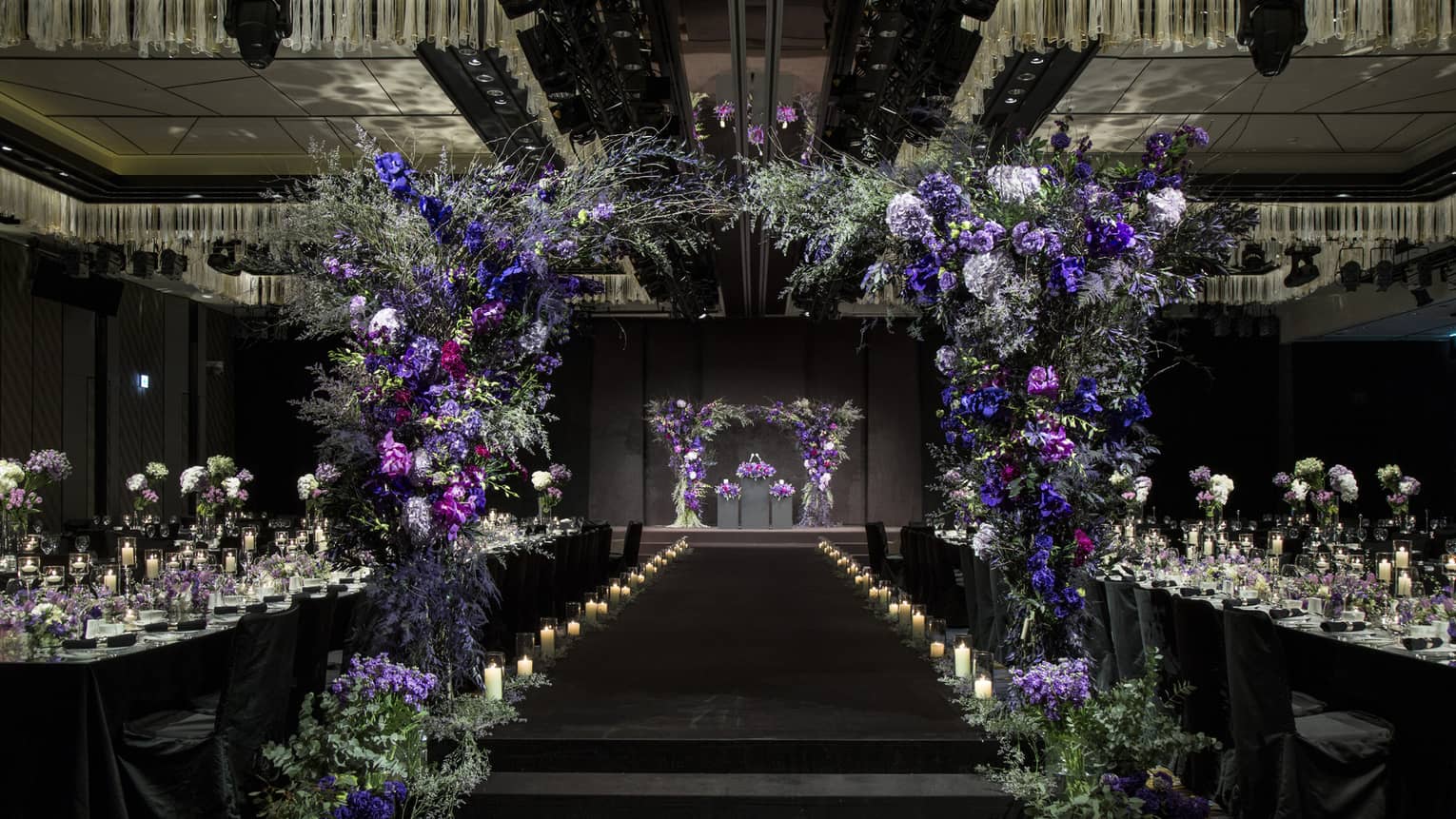 Glamourous Grand Ballroom II with candles and archway made of purple flowers