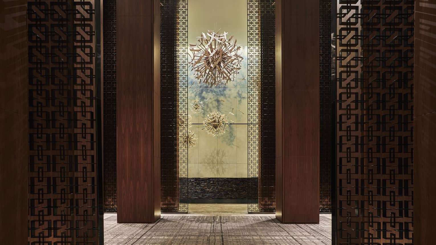 The interior lobby of FS Toronto, complete with bronze illusion walls, and dark oaky corridors.