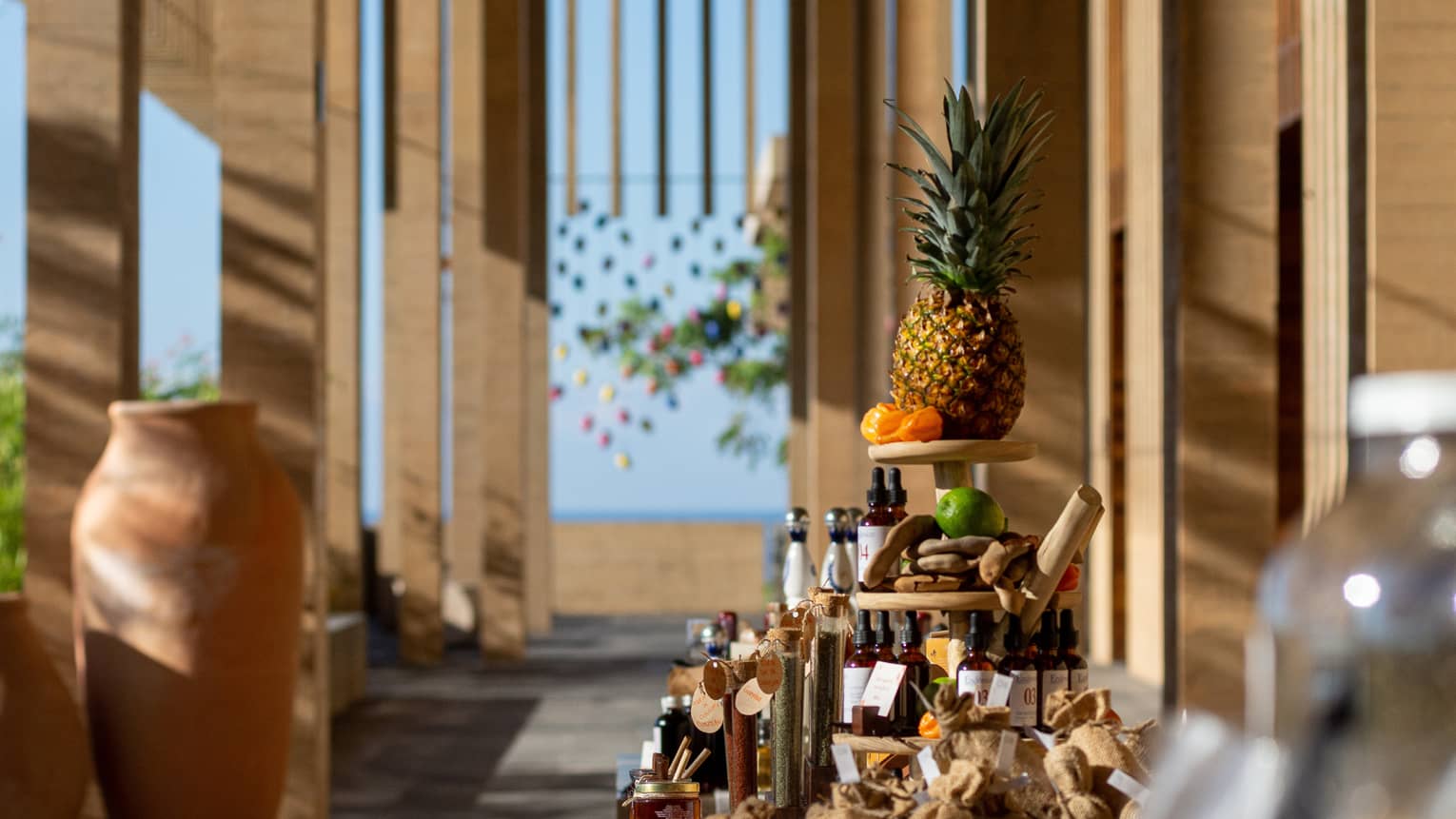 Display of various bottles and containers of items with a pineapple at the top of the display.