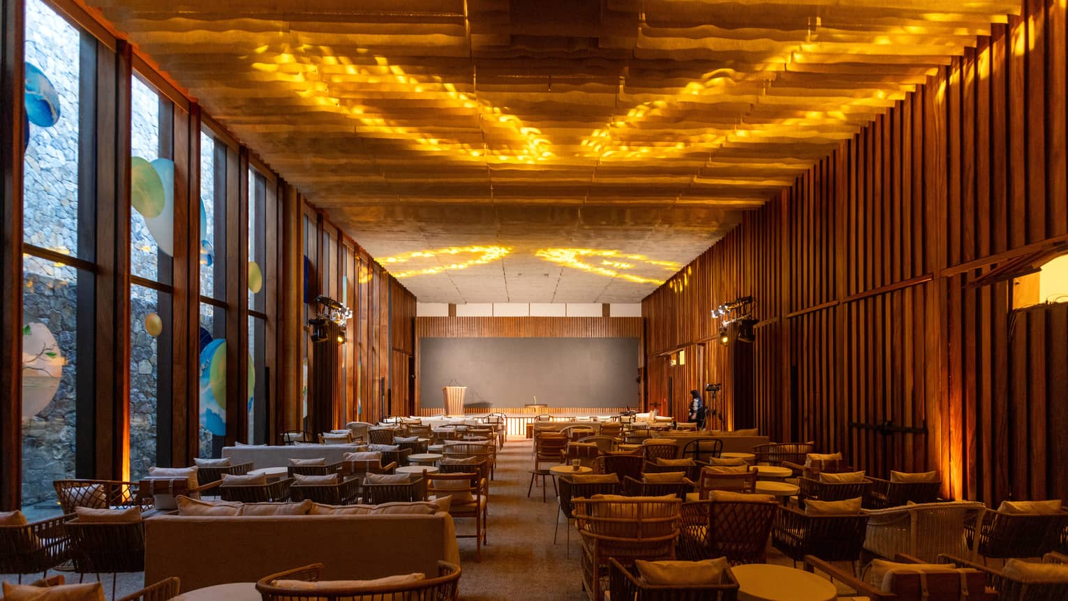 Event room with rows of chairs and lighting projected on the ceiling.