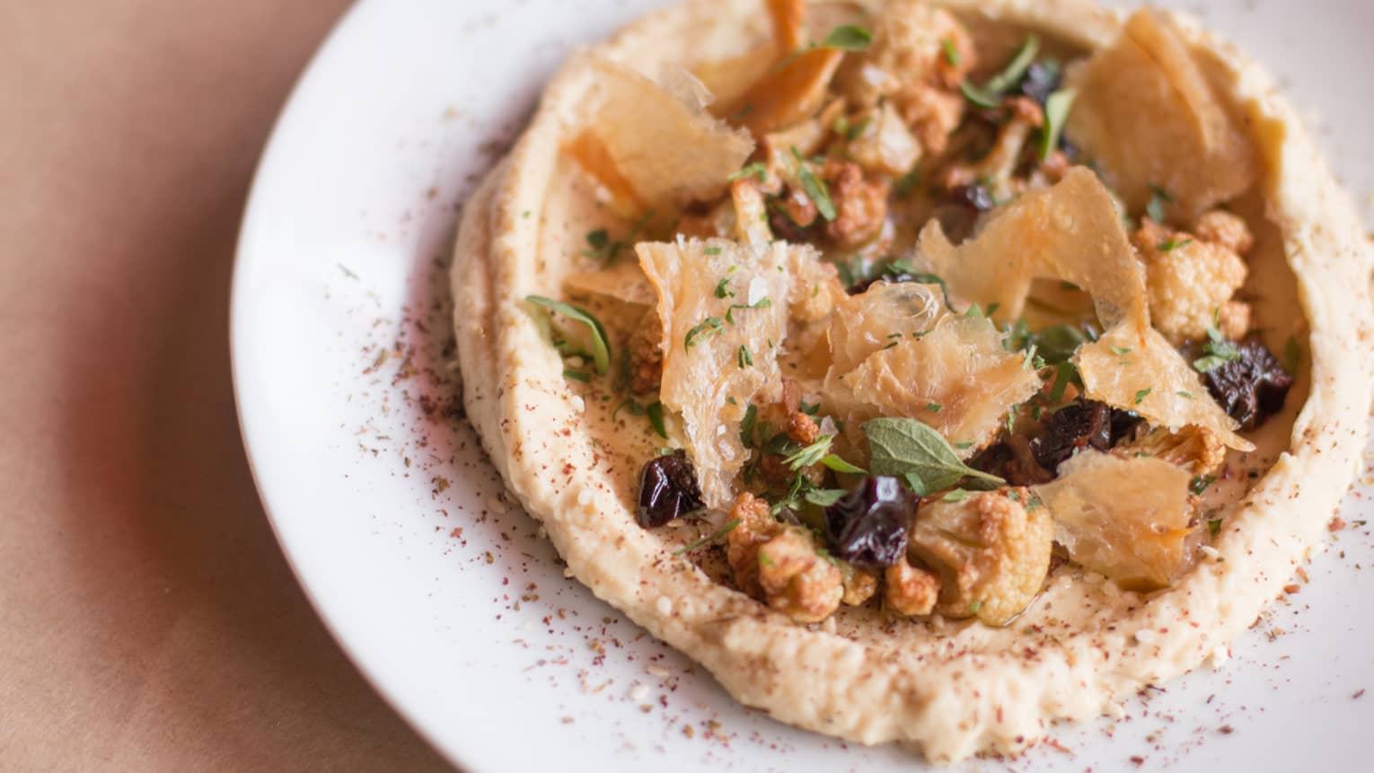 ENO Wine Bar appetizer, puree garnished with roasted cauliflower, black olives, herbs, flaky pastry