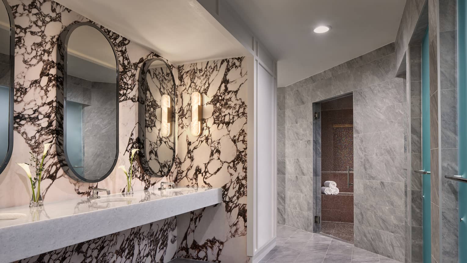 Spa room with faucets, mirrors on the wall and folded towels.