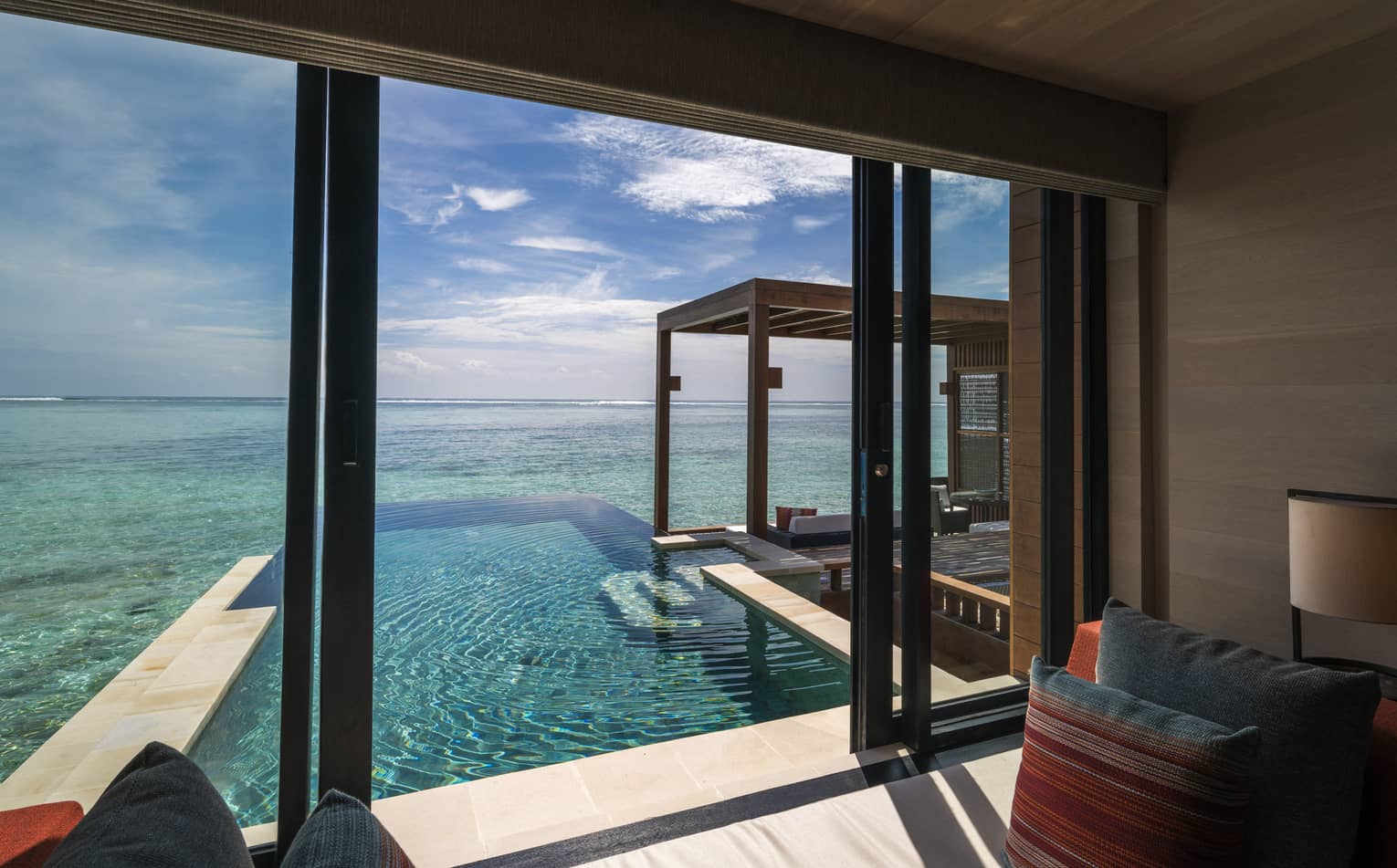 A view from inside the sunrise water villa with pool
