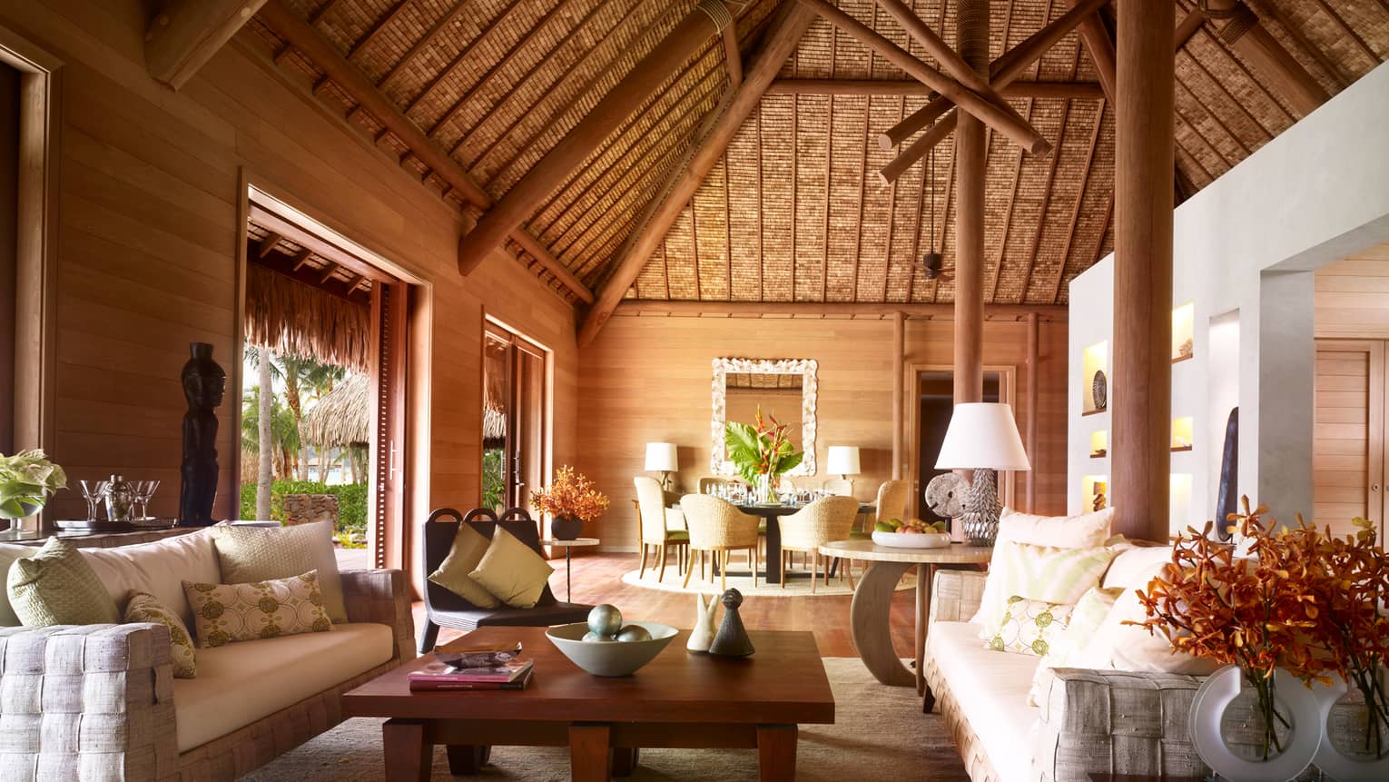 Large, bright bungalow with thatched cathedral ceiling, white sofas, Polynesian art
