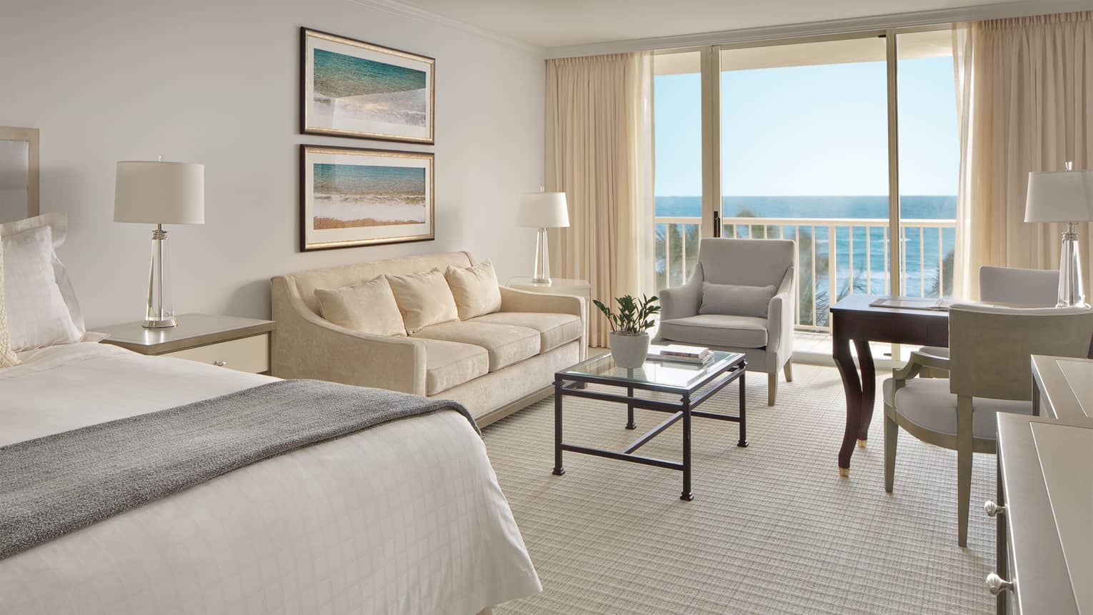 Premier Ocean-View Room with ivory sofa, ocean-inspired art and juliet balcony with beach view