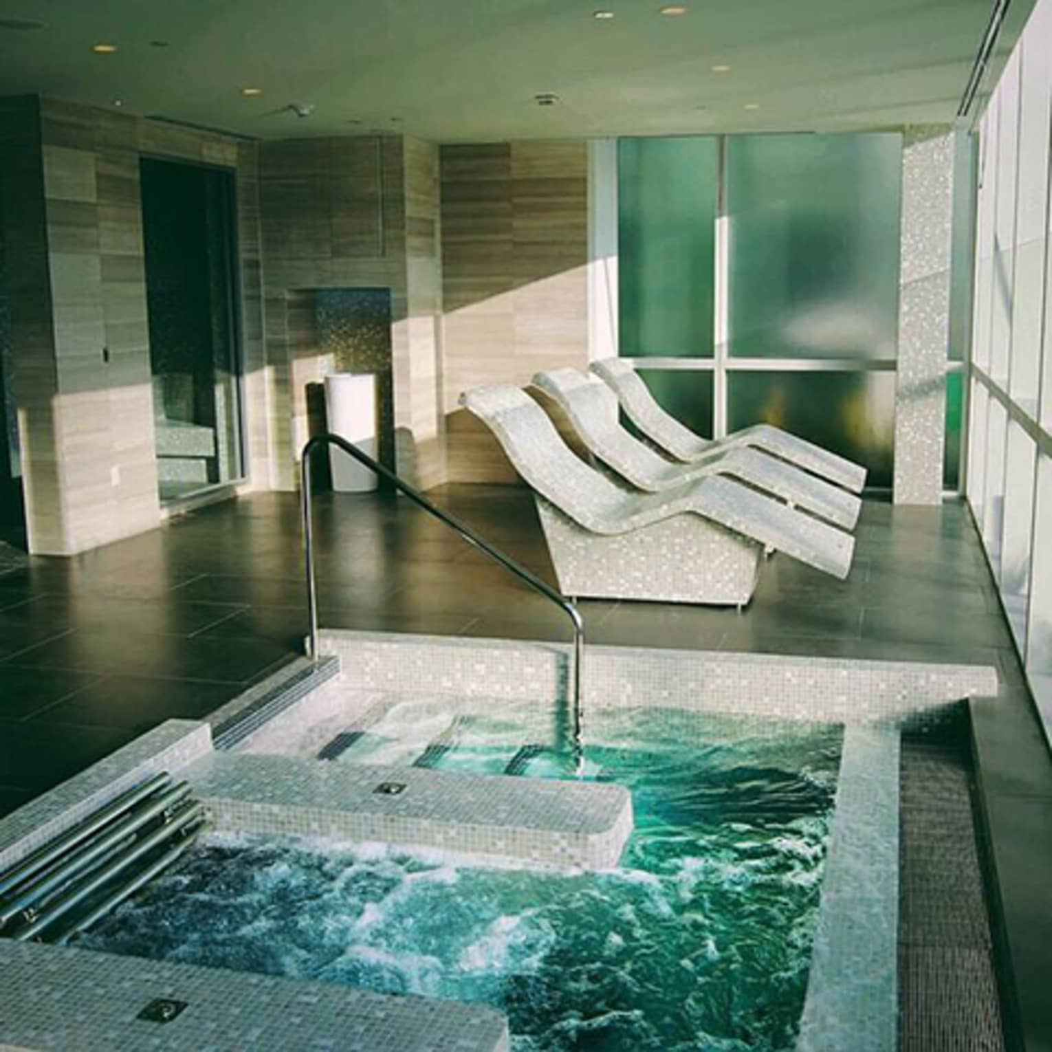 Spa room with three lounge chairs, hot tub