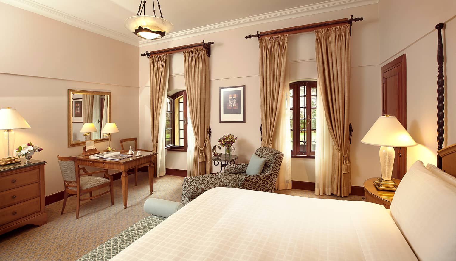 Superior Room bed, chaise, tables, two windows with long curtains