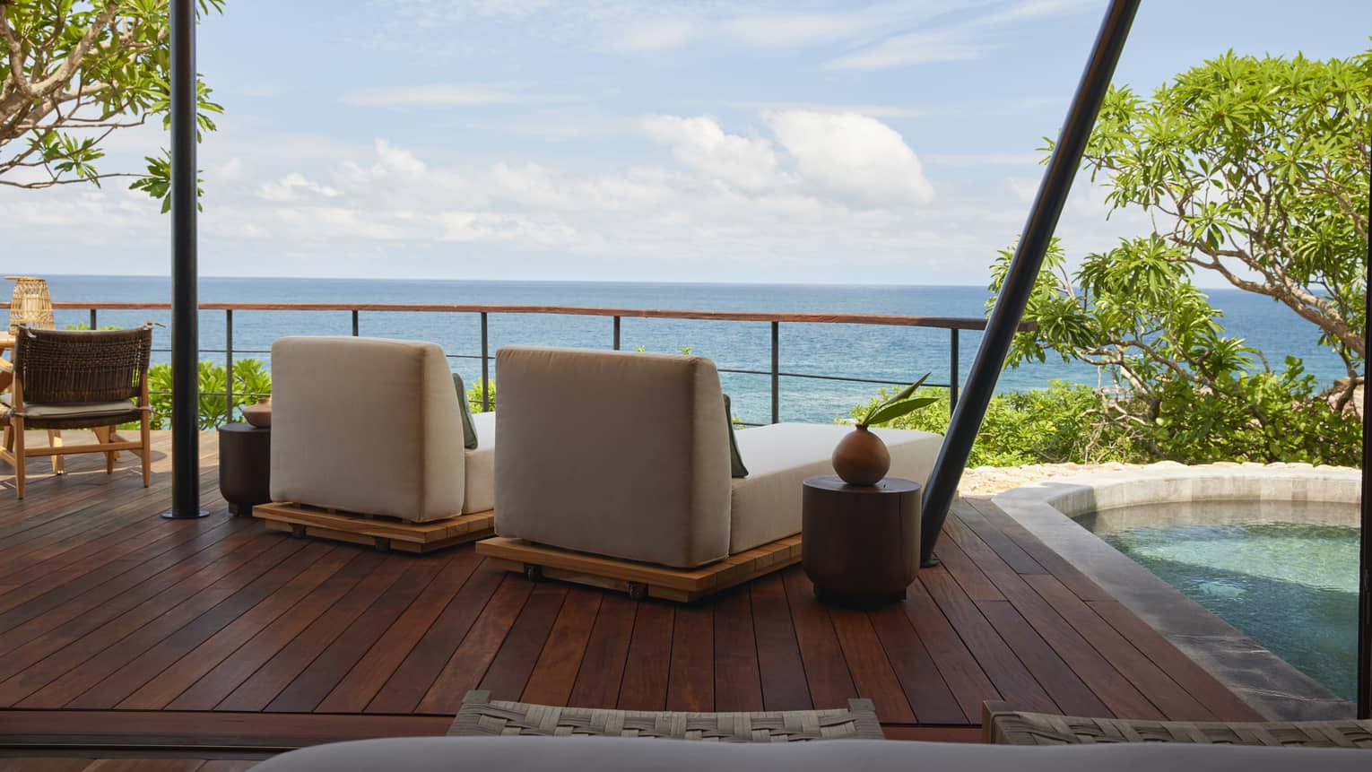Shaded deck of luxury tent overlooking the ocean, with private plunge pool and two lounge chairs