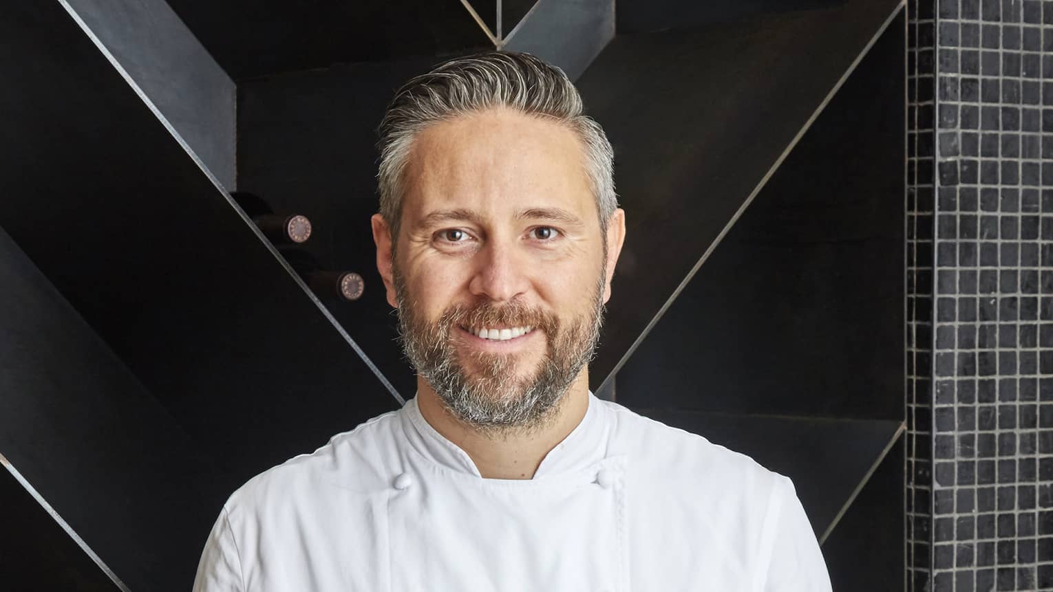 Chef Francesco Mannelli holds a platter of fish on ice
